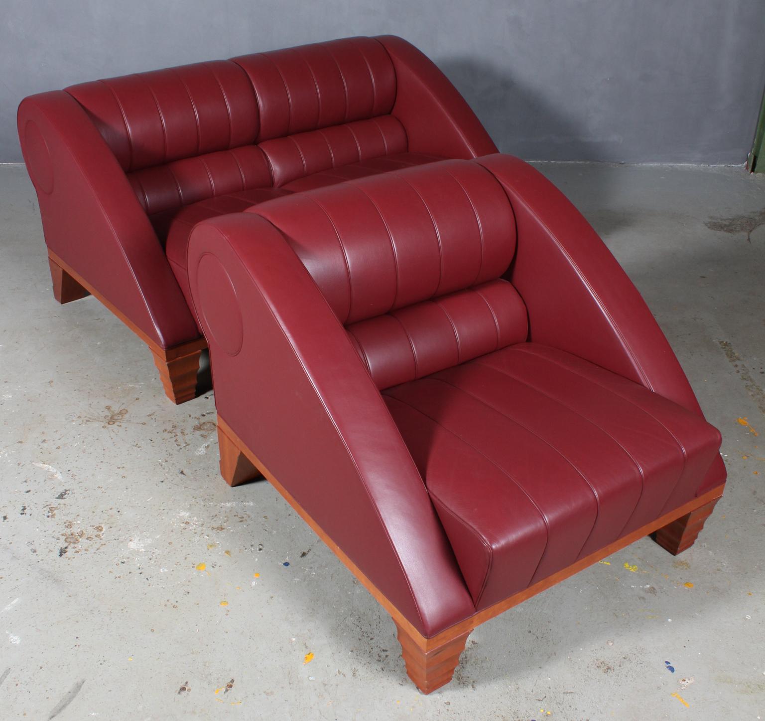 Leon Krier for Giorgetti. Two-seat sofa and lounge chair upholstered with Indian red leather.

Frame of cherry.

Model Aries, made by Giorgetti.