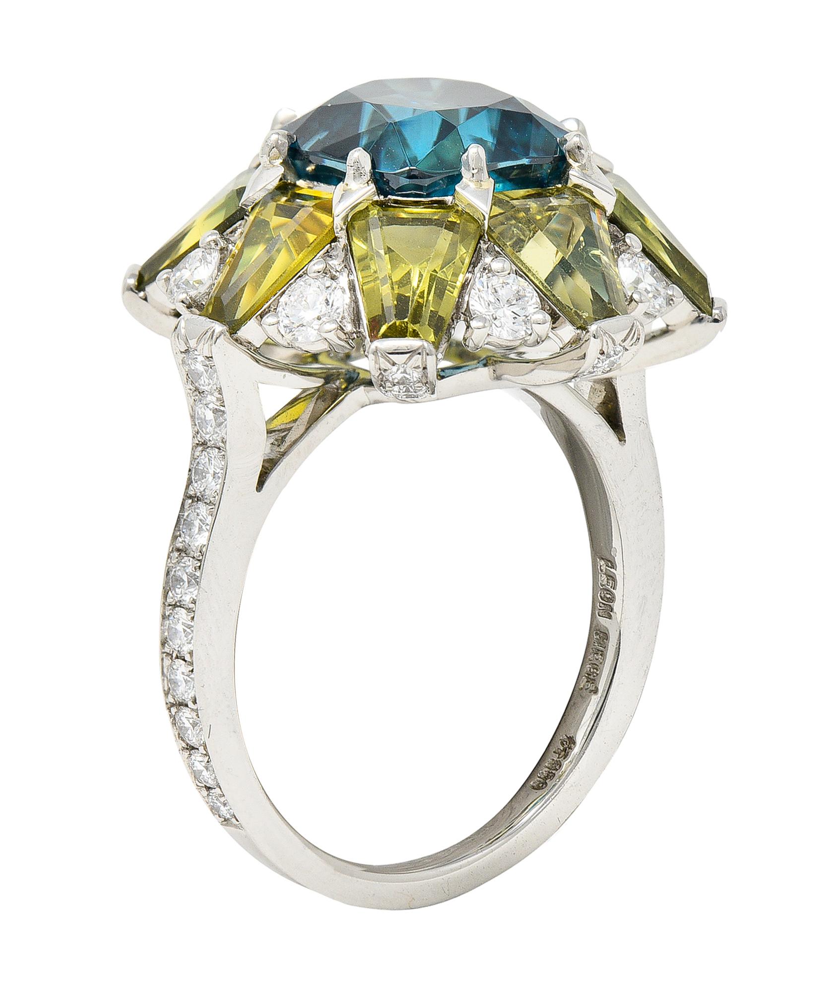 Featuring a substantial cushion cut zircon weighing approximately 7.00 carats

Eye clean with striking slightly greenish strongly blue color

Surrounded by a halo of keystone cut green sapphires

Weighing in total approximately 4.00 carats with well