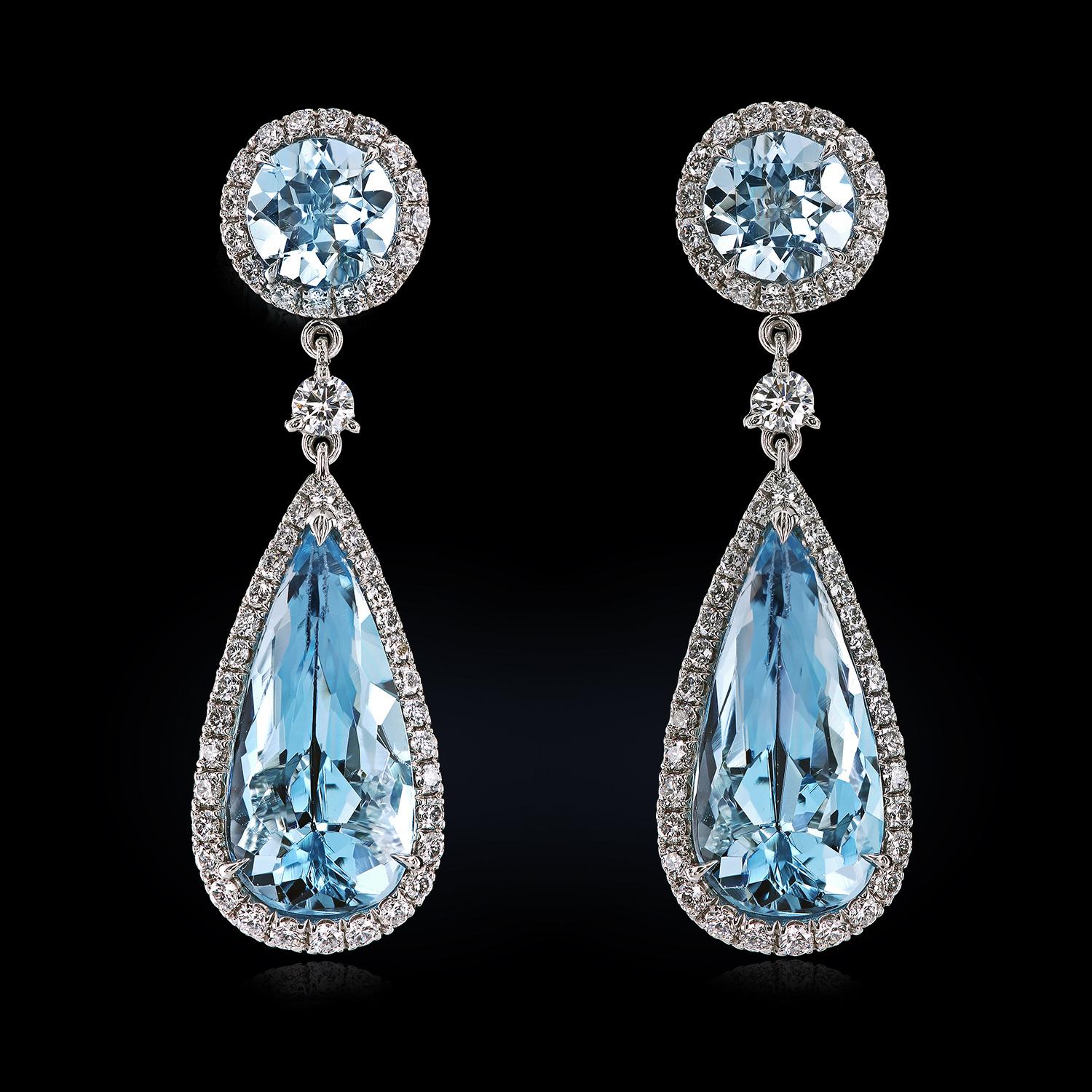 Bespoke earrings featuring 8.13 carats of natural aquamarines and 0.96 carats of finest diamonds. The platinum drops are easy to convert to a pair of studs by sliding the pendants off the post. They can be worn as studs during the day and as