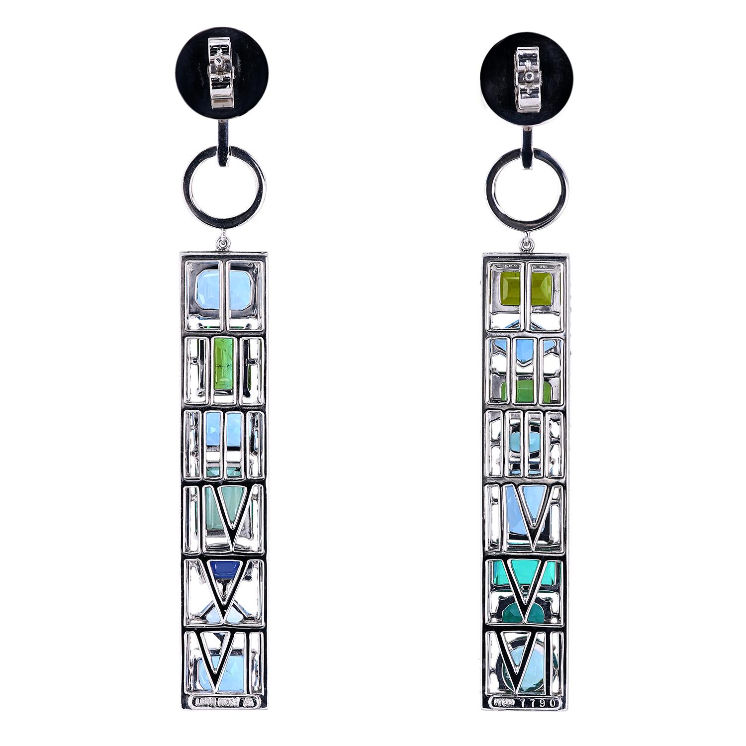 One-of-a-kind platinum earrings set with a total of 15.55 carats of natural gemstones - tourmaline, aquamarine, and sapphire.
Hinged, 10 mm post with butterfly-style self-locking pushbacks.
The frame has micro pave detail combining 222 full-cut