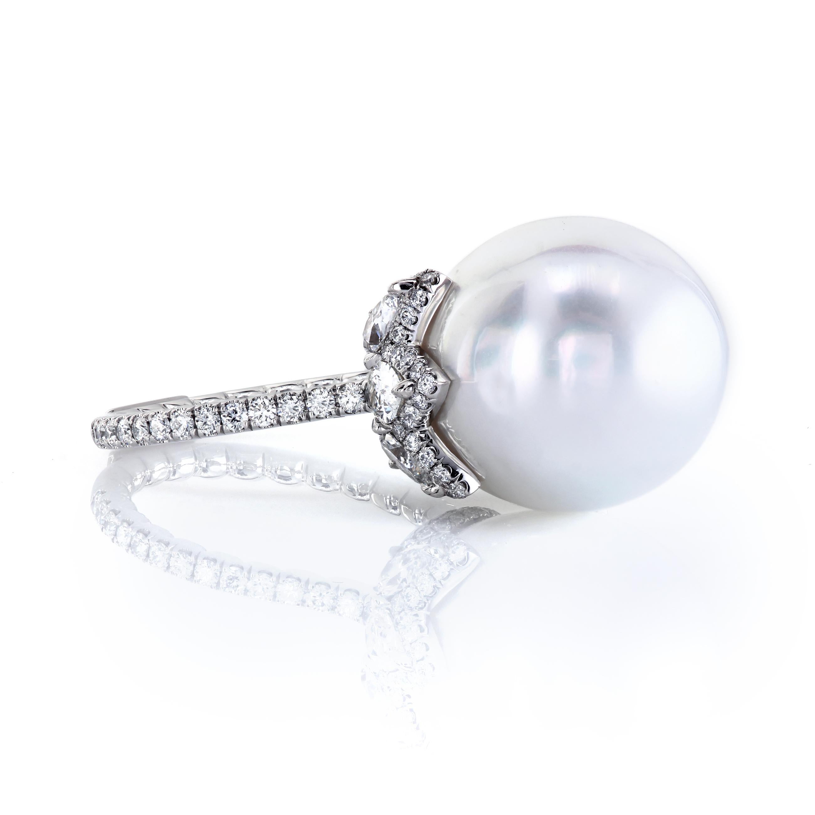 Stunning and elegant platinum ring. The beautiful combination of the slightly elongated pearl and the fiery of diamonds will be admired and cherished for years to come. Pearls symbolize love, success, and happiness. Look around - do you know anyone