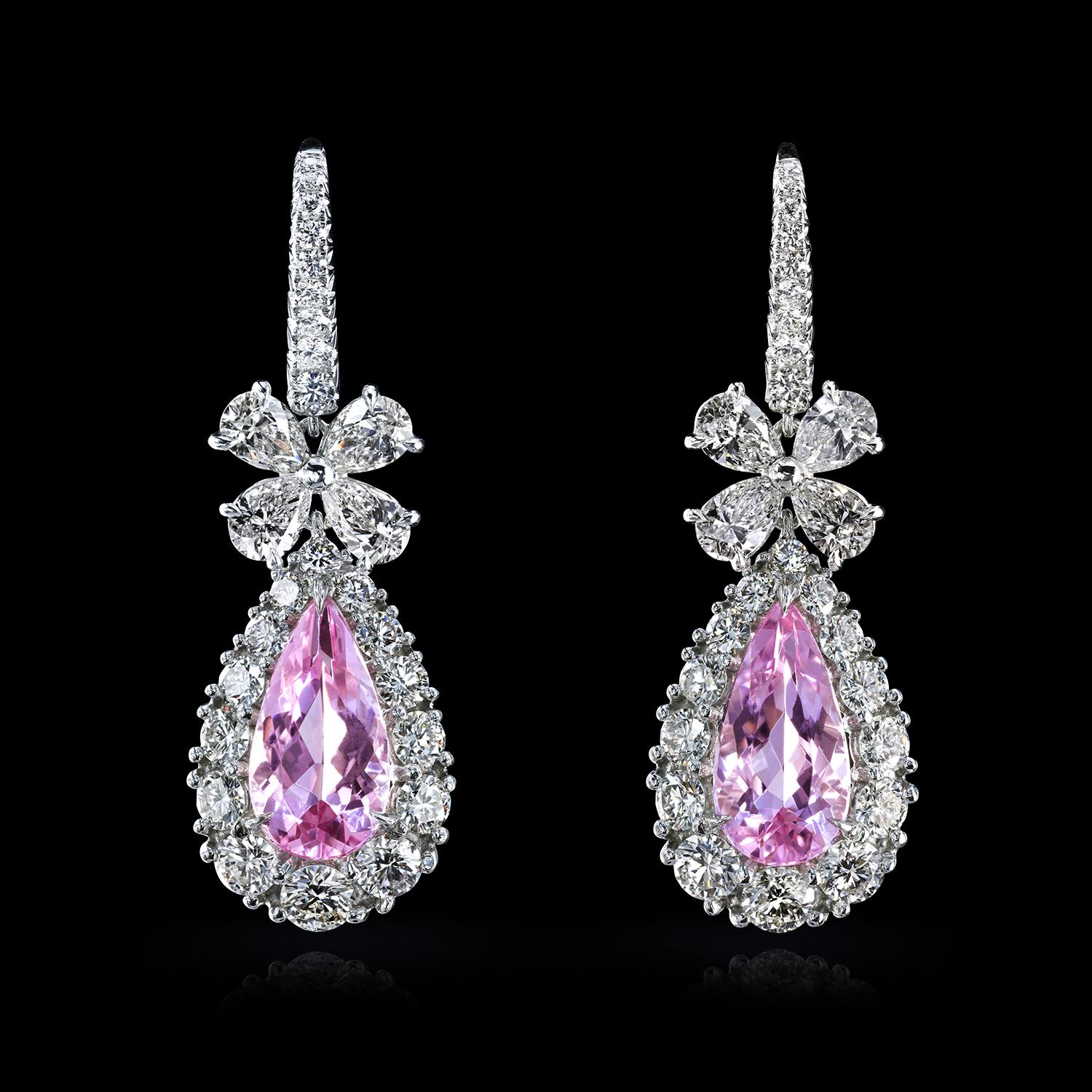 Fabulous platinum drop earrings feature pink emeralds - natural morganites just under two carats, each embedded in graduated diamond clusters. The pear-shaped pendants, diamond bows, and pave-studded French wires are connected with flexible hinges