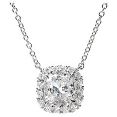 Leon Mege platinum halo pendant features an Antique cut cushion diamond.