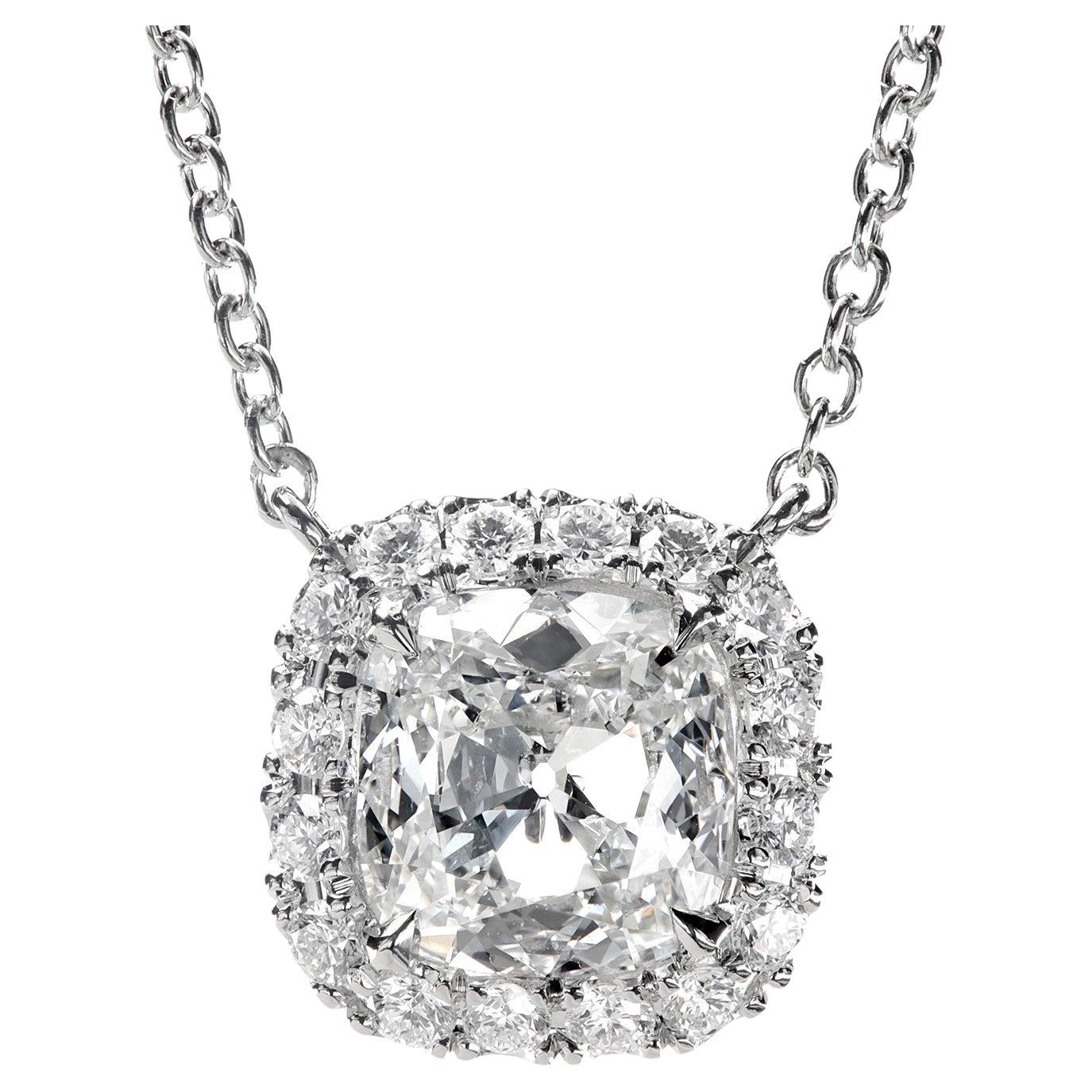 Leon Mege platinum halo pendant features an Antique cut cushion diamond.
