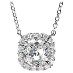 Leon Mege platinum halo pendant features an Used cut cushion diamond.
