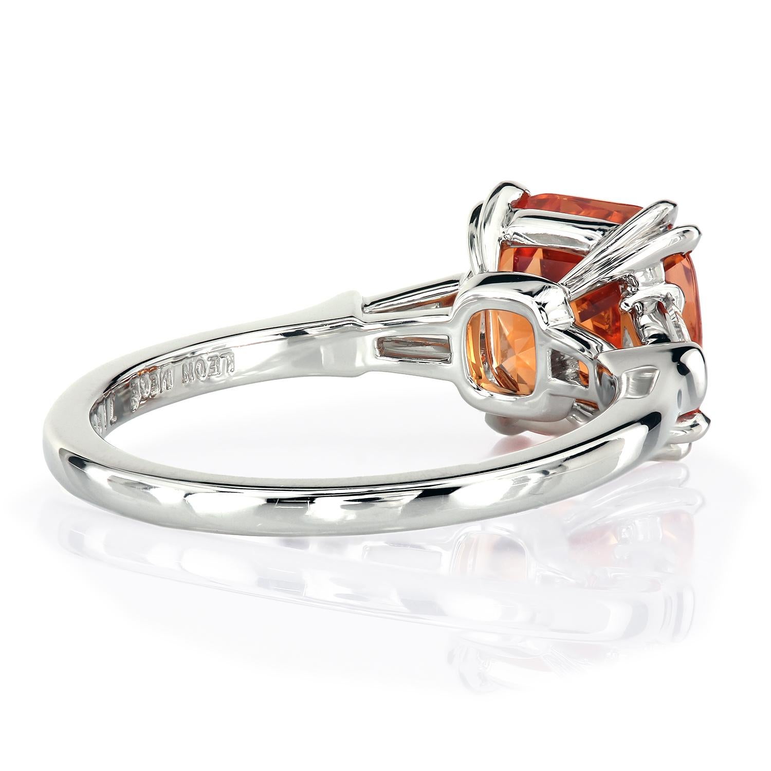 Classic platinum three-stone ring featuring a 3.44-carat cushion Mandarin garnet.
The vibrant orange stone is held with double claw prongs and is flanked by a pair of tapered diamond baguettes, 0.25 ct total weight, G-H/VS
