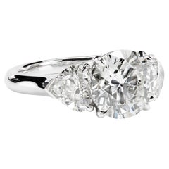 Leon Mege platinum three-stone ring with round and heart-shape diamonds  