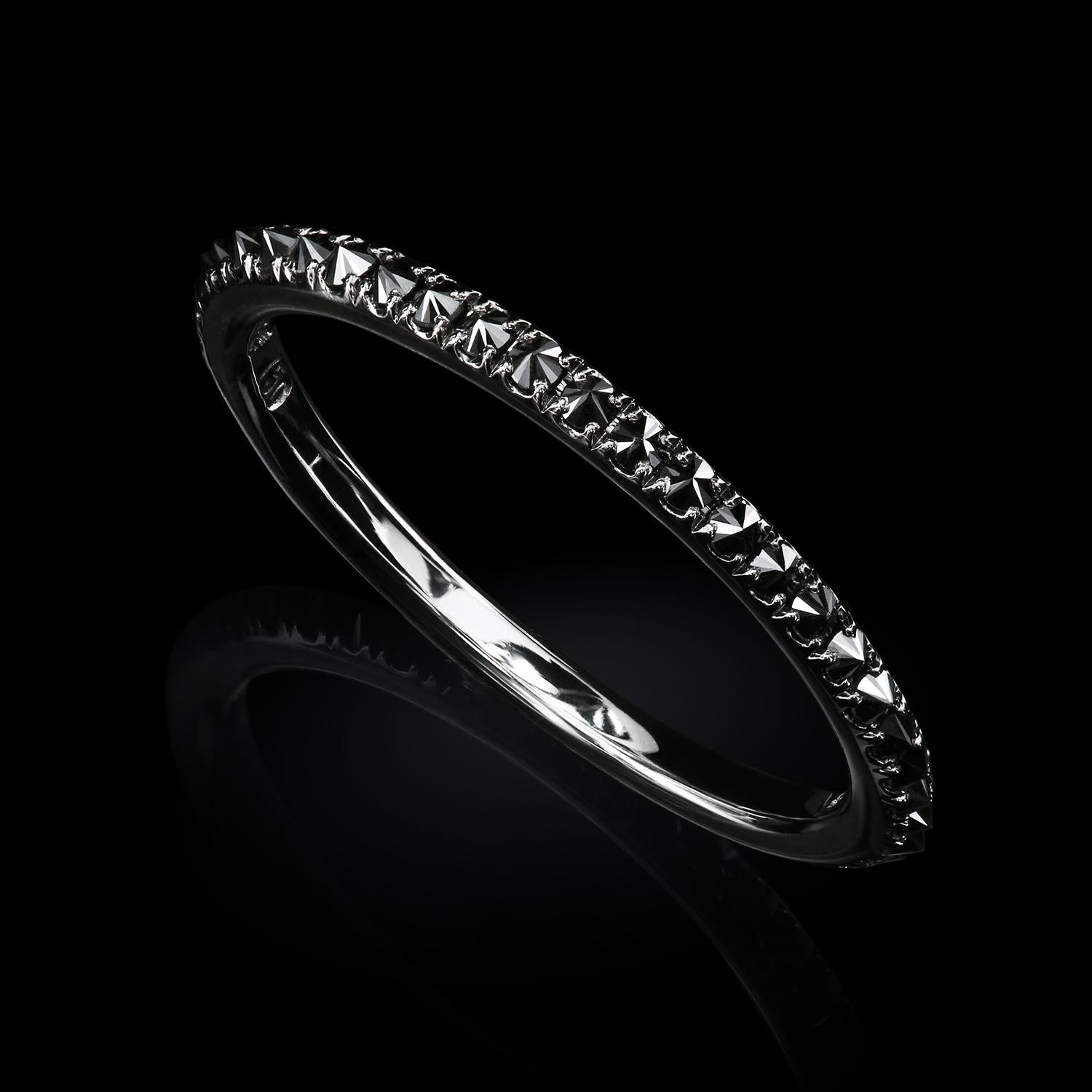 The cool futuristic band designed for visionaries who detest ordinary can be mistaken for an alien spaceship spare part at first. The 18K black gold band holds natural black diamonds set upside-down for dramatic effect.

1.70 mm in width
18K white