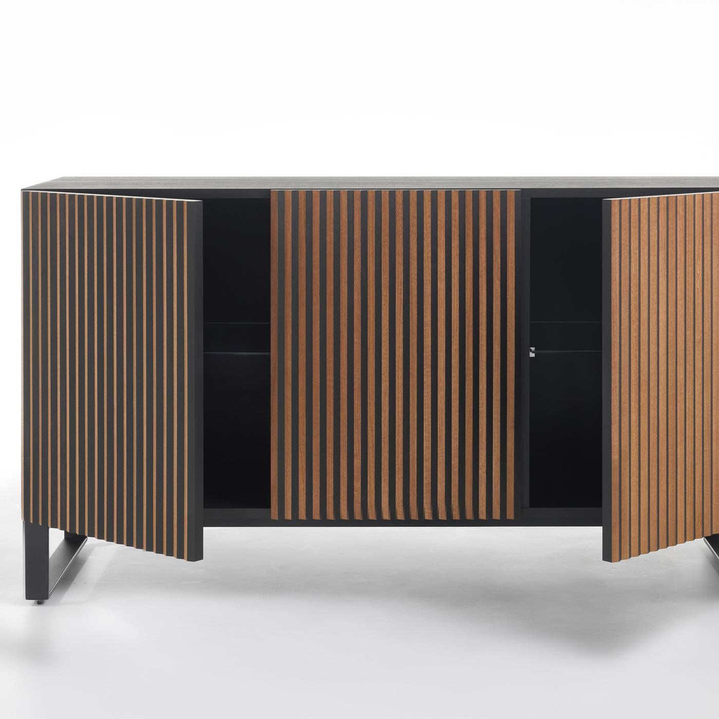 This two-door sideboard by StH is an exquisite, modern objet d'art, boasting captivating visual contrasts. It is crafted of mocha-finished beechwood and features two black ABS feet (2 cm high).? Boasting unique optical effects, the front panels are