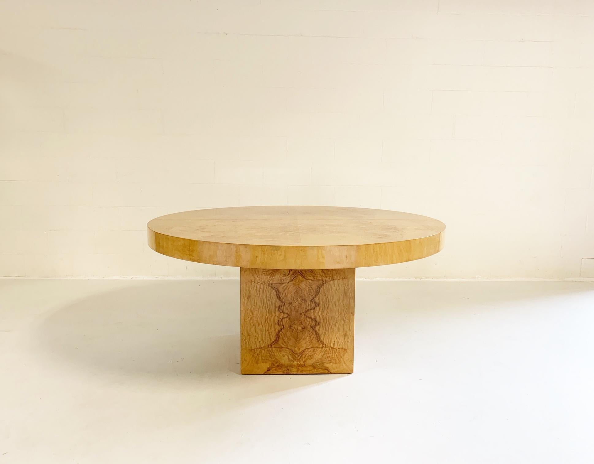 Attributed to Leon Rosen, this dining table is so dynamic. With 2 leaves, it can easily fit 10 dining chairs. Without the 2 leaves, the table squeezes together to form either a nice pedestal dining table for 4 chairs or even a perfect round table