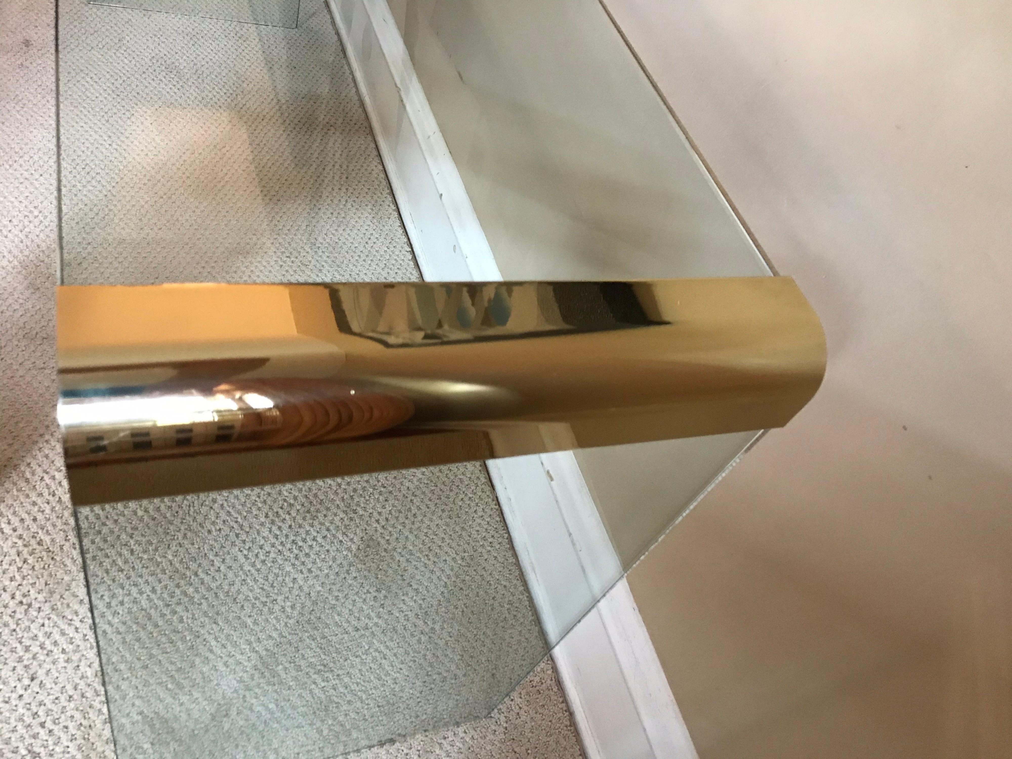 Thick 3/4 glass plinths are secured by substantial brass connectors. Minimalist while remaining a striking statement piece.