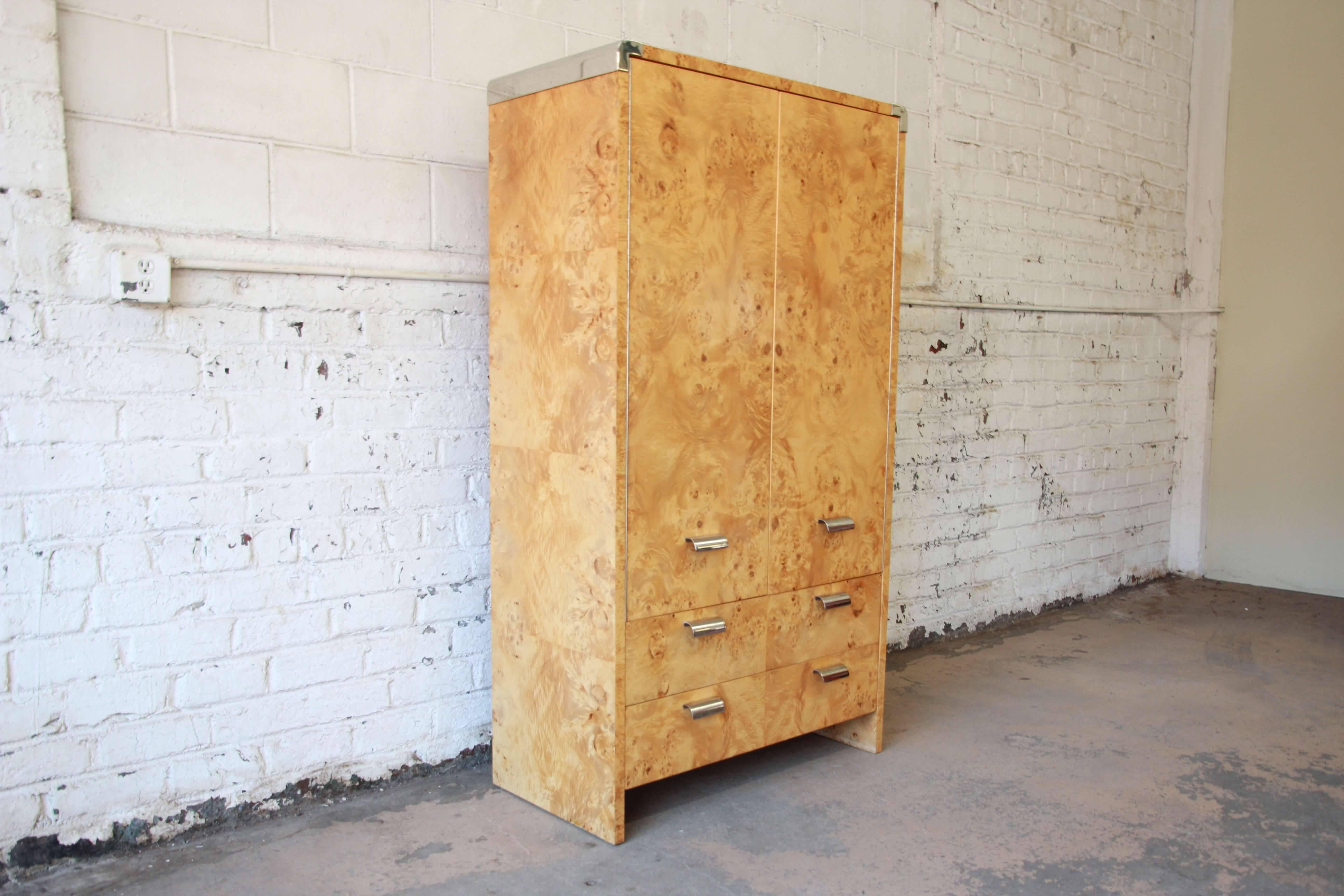 Offering a beautiful burl wood and chrome wardrobe dresser designed by Leon Rosen for Pace. The dresser has two large cabinet doors that open up to four drawers on the right, two adjustable shelves on the left, and a larger shelf above. There is