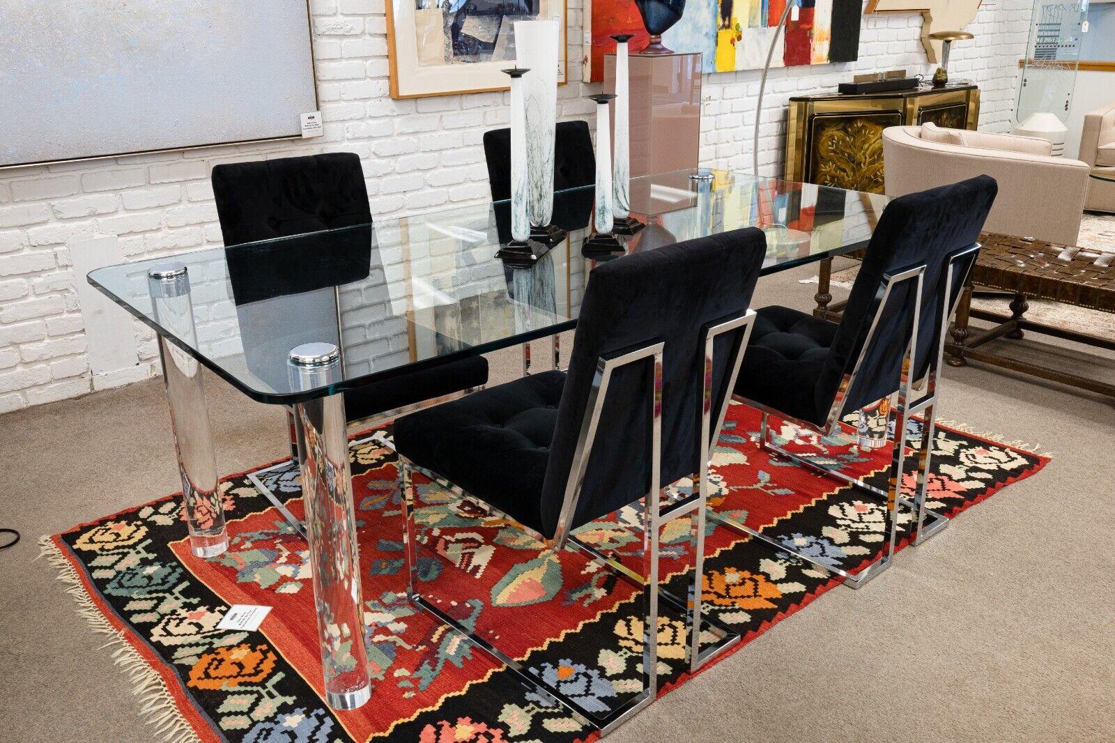 A Leon Rosen for Pace chrome & Lucite glass dining table. A fantastic dining table from designer Leon Rosen for Pace furniture company. This awesome table features a thick, glass table top, round Lucite legs, and chrome toppers for the legs which