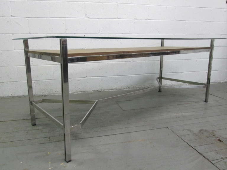 Large unique desk with a flat chrome-plated steel base.