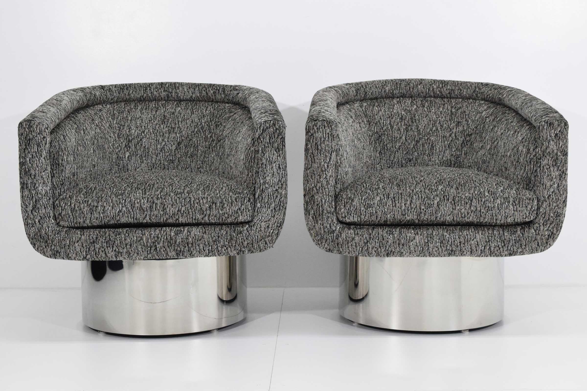 Pair of handsome tub chairs on steel clad round swivel pedestal base by Leon Rosen for Pace Collection. Swivel is self correcting. These have new upholstery on them by Romo Black.