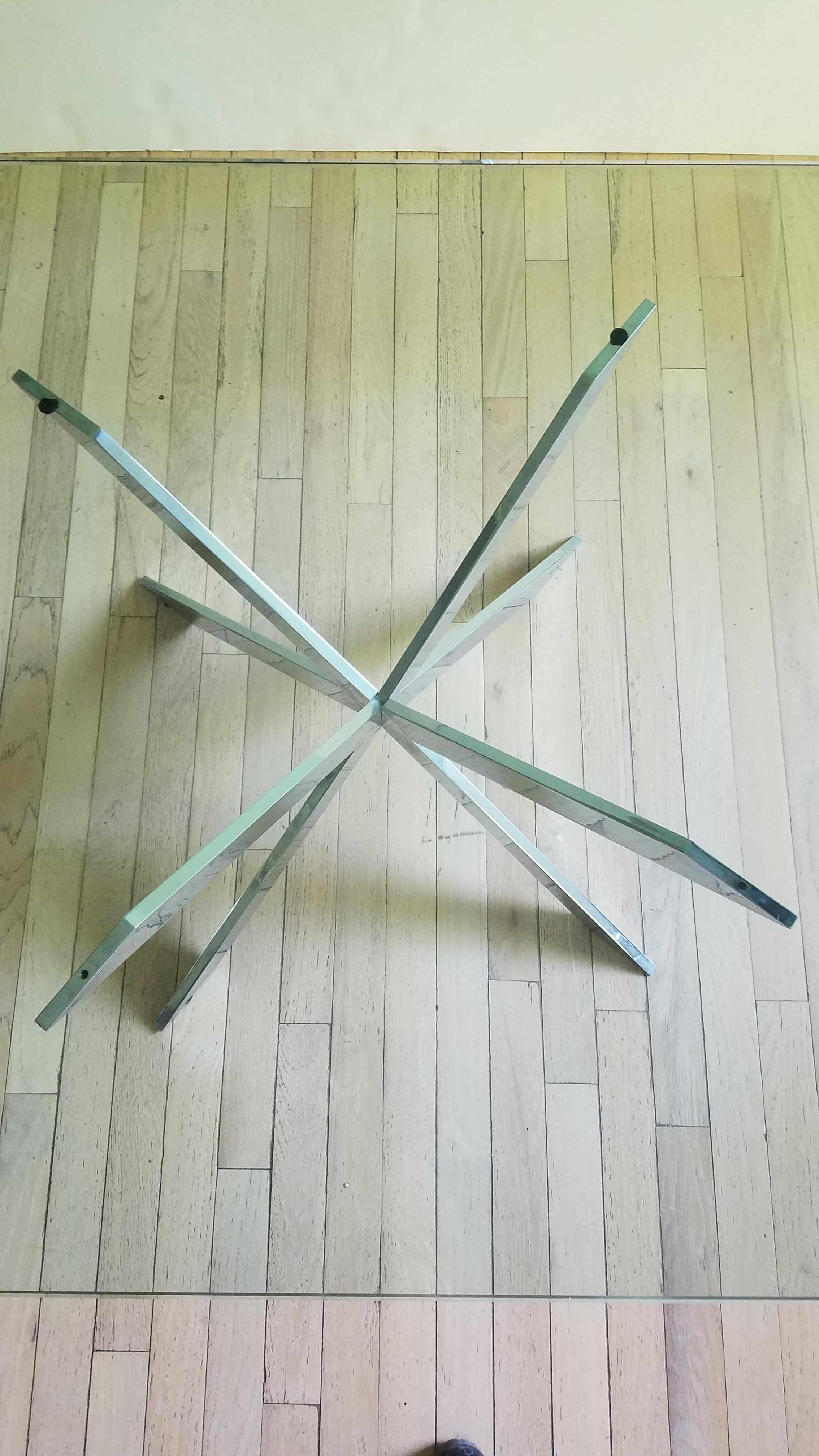This iconic double X-base glass-topped cocktail table was designed by Leon Rosen for the Pace Furniture Collection in the 1970s. The base of intersecting X-forms is of chromed steel.

Leon Rosen designed many iconic pieces for the Pace Furniture