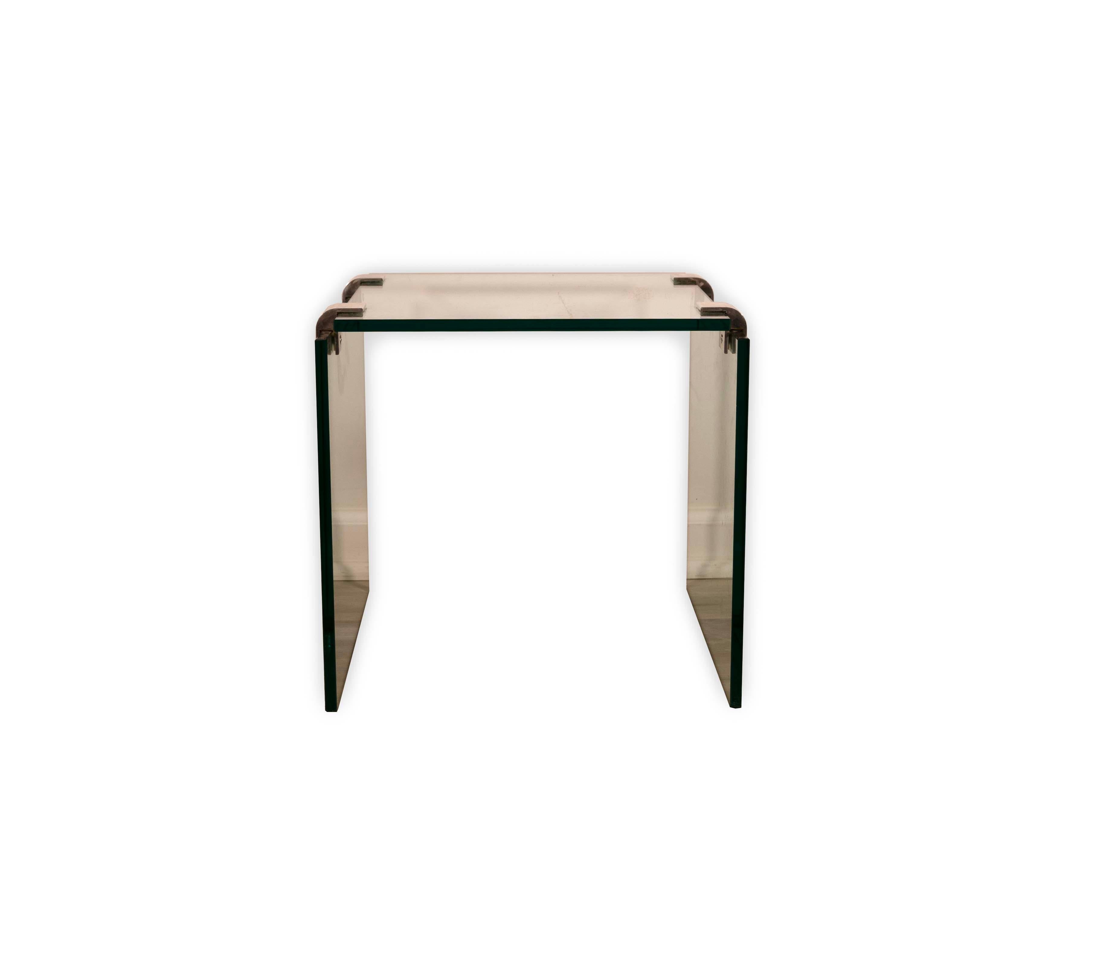Sleek and modern, the Leon Rosen for Pace Side End Table exudes sophistication and elegance. Crafted with a seamless blend of lustrous chrome and clear, tempered glass, this end table epitomizes the minimalist chic of the mid-20th century design.