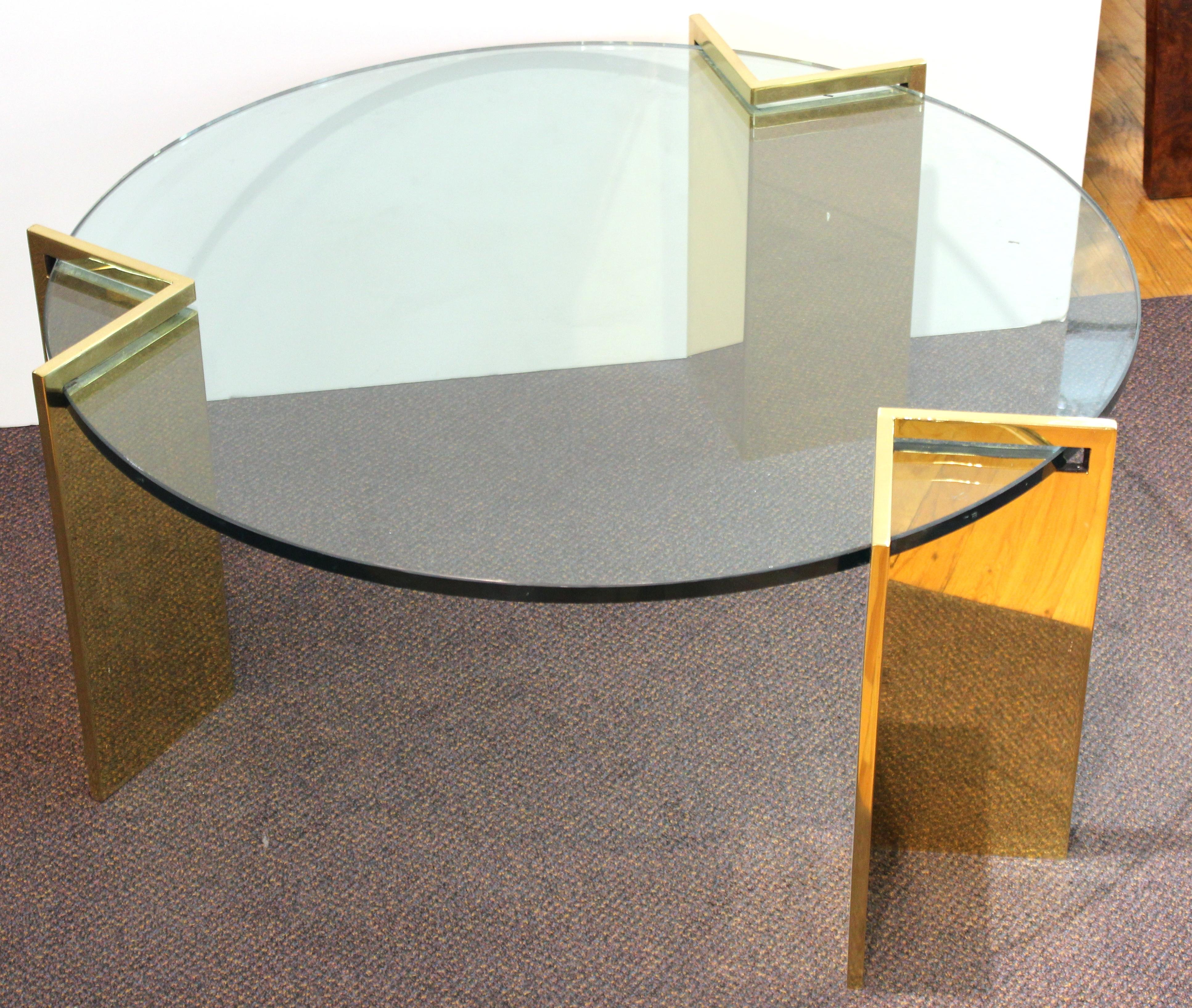 Modern cocktail or coffee table with metal legs and a round heavy glass top, designed by Leon Rosen for Pace during the 1970s. The piece is in great vintage condition with age-appropriate wear.