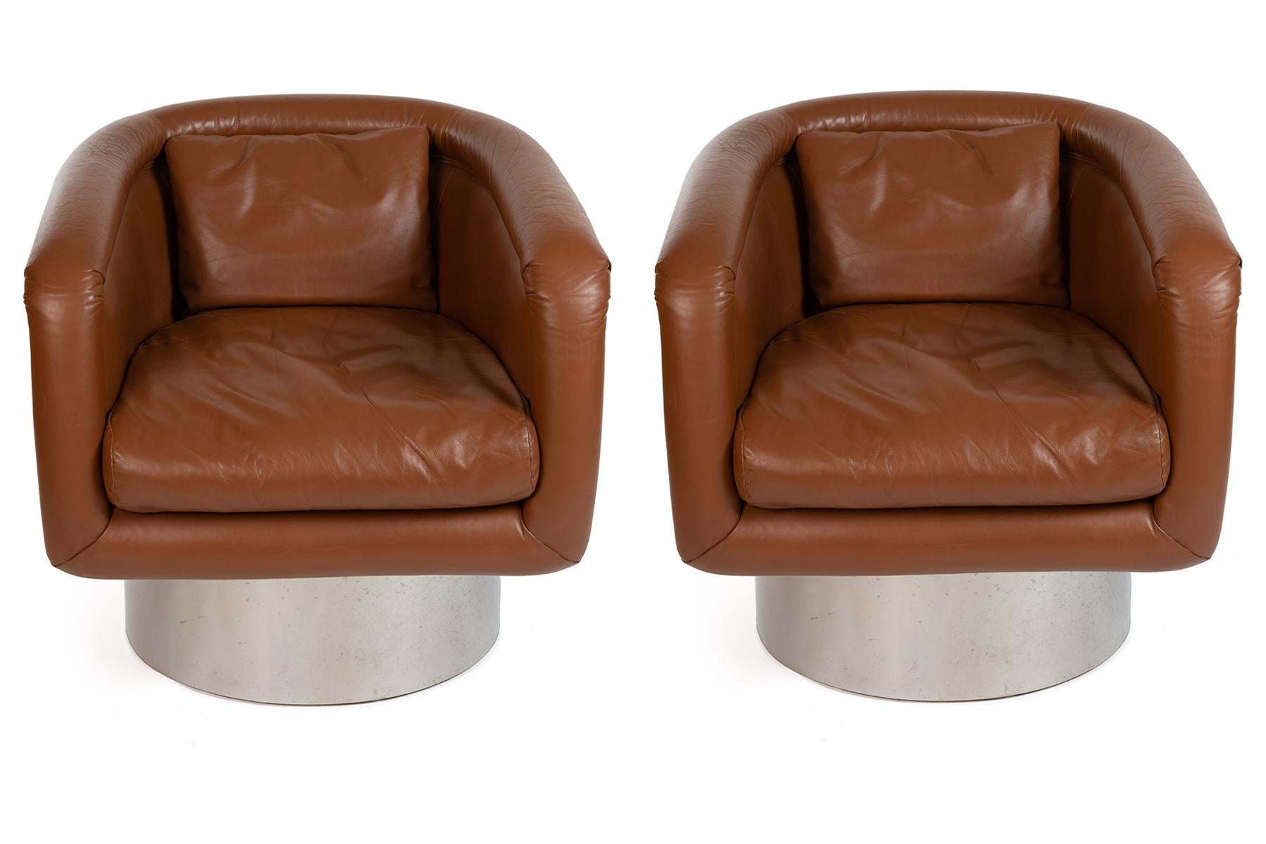 All original Leon Rosen for Pace swivel leather lounge chairs, circa early 1970s. These examples retain their original milk chocolate leather upholstery and steel bases. Price listed is for the pair.