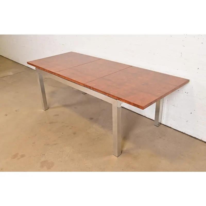 An exceptional Mid-Century Modern extension dining table

By Leon Rosen for Pace Collection

USA, Circa 1970s

Gorgeous book-matched burl wood top, with chrome base and legs.

Measures: 64