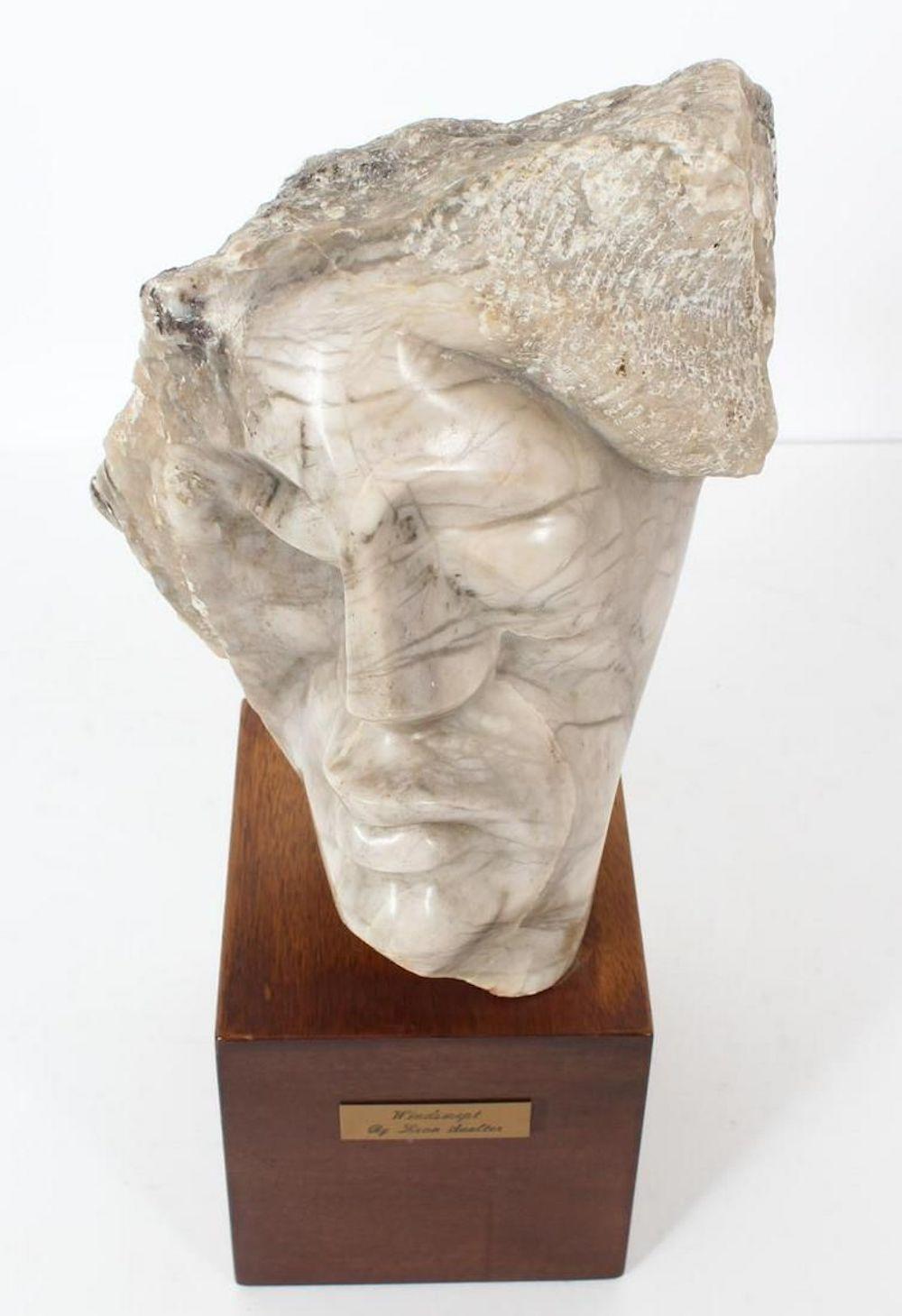 Windswept Face Of A Man Marble Sculpture 
Signed, on wooden base.
Leon Saulter (1908 - 1986) was active/lived in California  born in Poland. Moved to US in 1921. Leon Saulter is known for sculptures, paintings also writer. 
Born in Poland on March