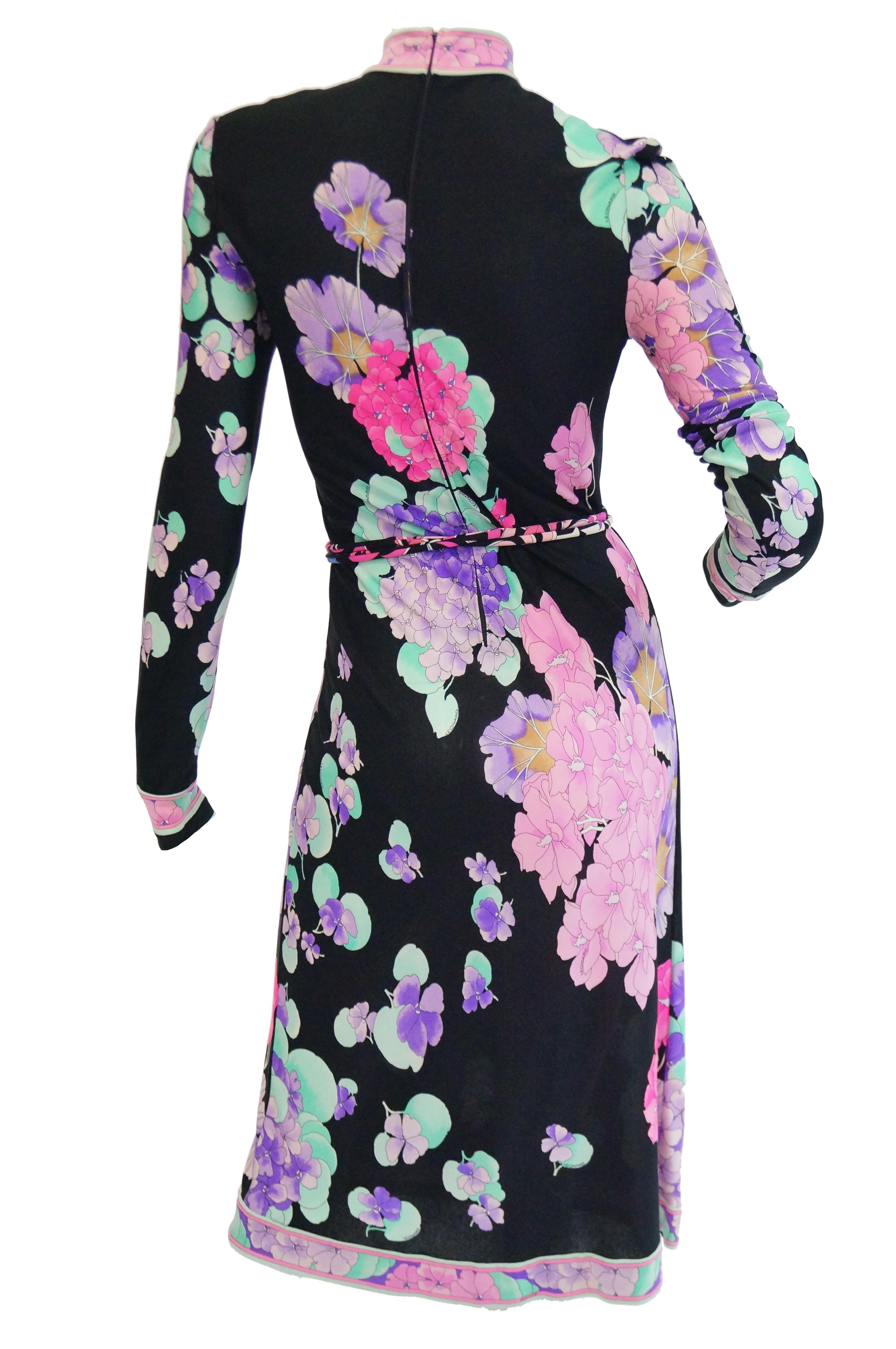 Summer floral midi dress featuring Leonard's signature fabric! Dress has a high neck which brandishes Leonard's classic orchid design that plays well with the negative space of this dress.  The sleeves are long with contrasting floral bands.