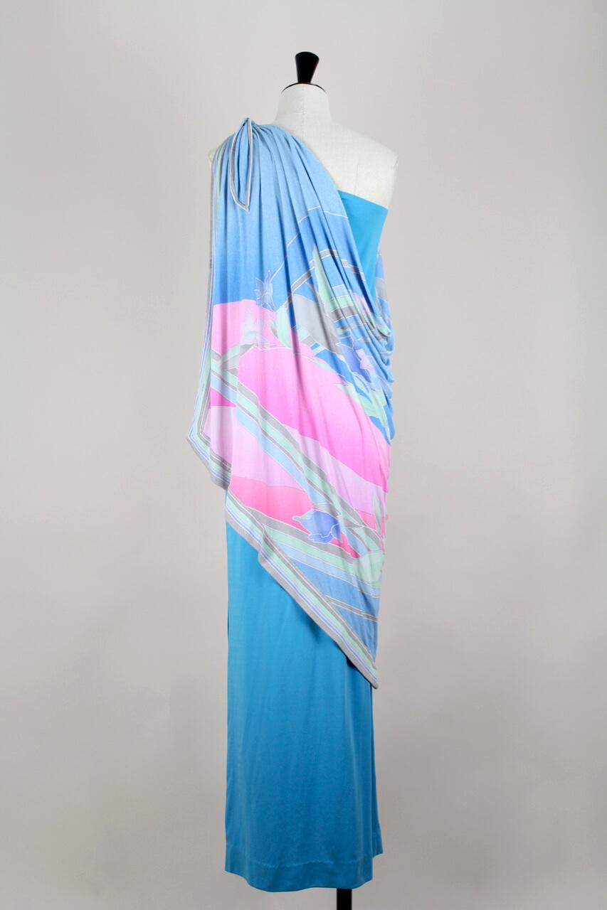 This fabulous 1970s Leonard one shoulder maxi dress is a find! It is constructed of a sleek maxi length dress that is cut from a french blue synthetic jersey and has a long side hem vent.

Attached to that dress at the shoulder is a shawl made from