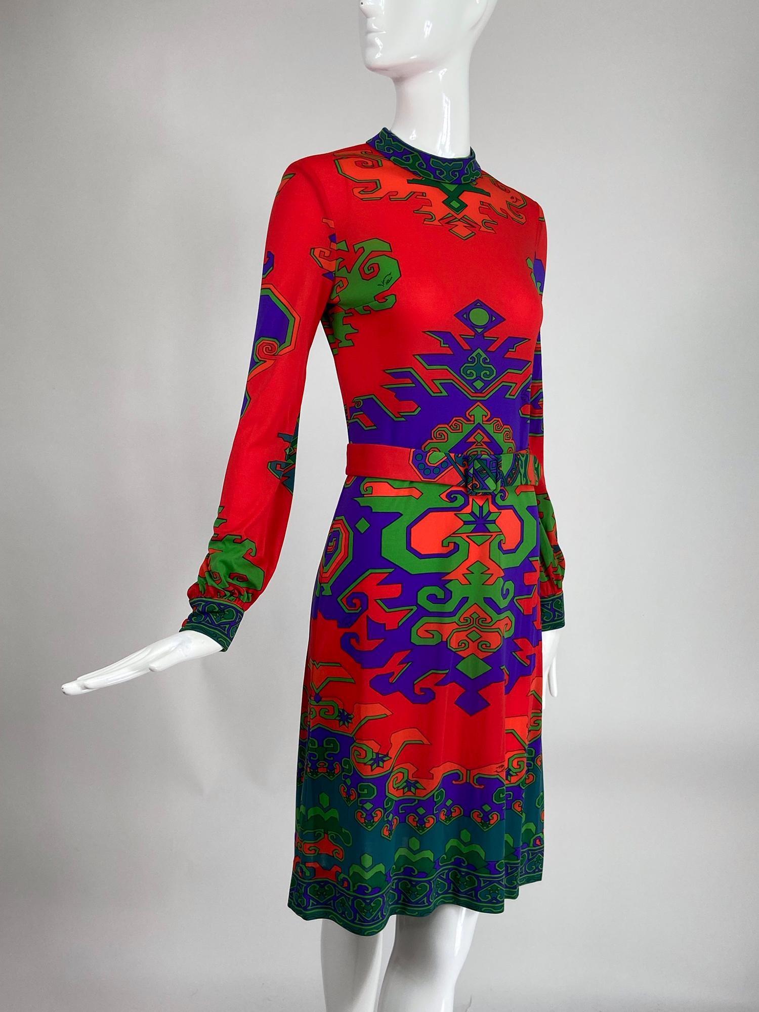 Leonard Fashion Paris silk jersey Geometric design dress from the 1970s. Bold geometric design print pops against the red jersey dress. Mock neck dress has long sleeves that are gathered into banded cuffs that close with 2 self buttons, the dress