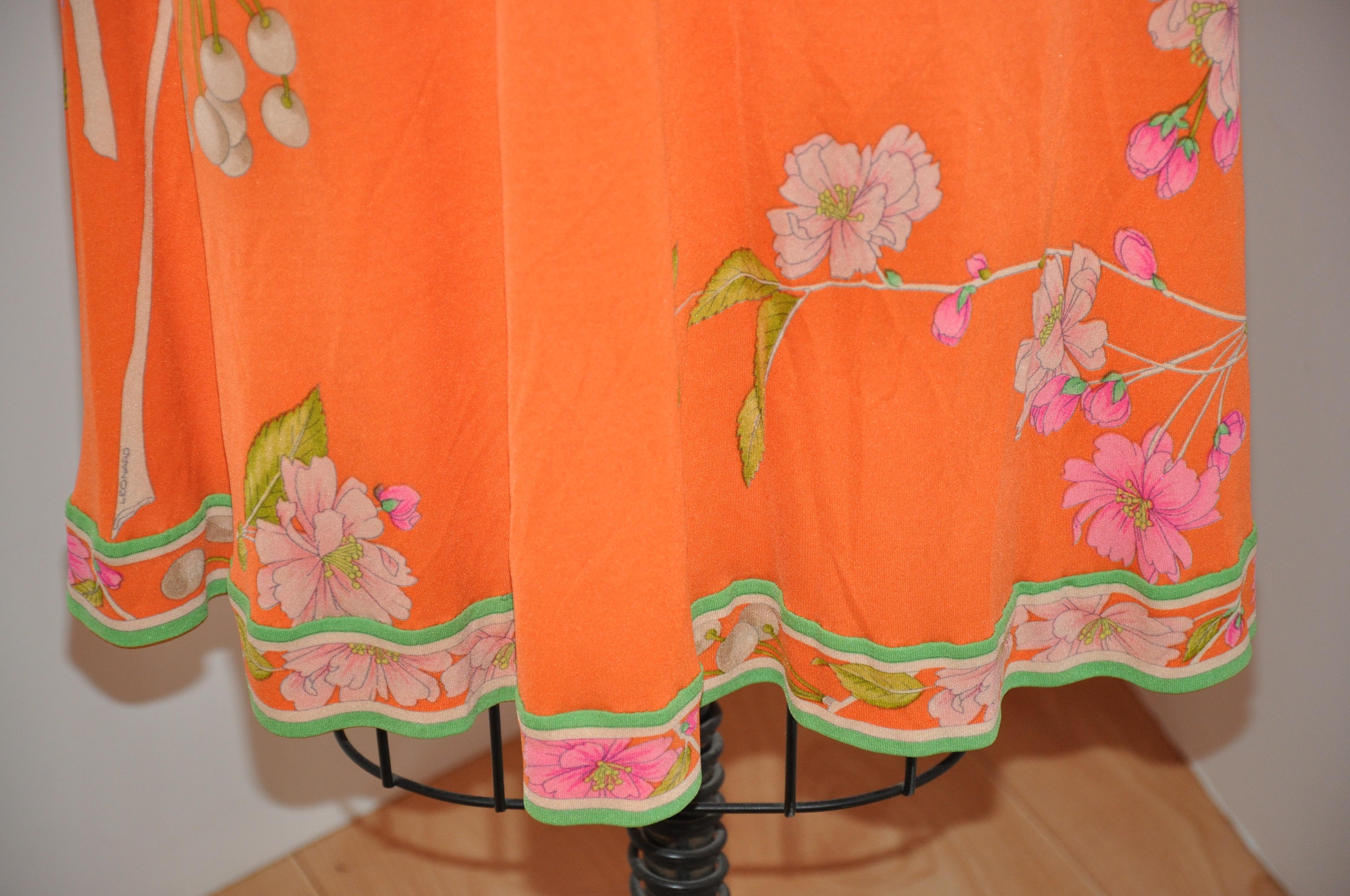    Leonard of Paris lovely and elegant powder-tangerine with floral-print has a center-back zipper which measures 20 inches and hand-sewn. The length in front measures 38 inches, back is 44 inches. The underarm circumference is 36 inches, shoulder