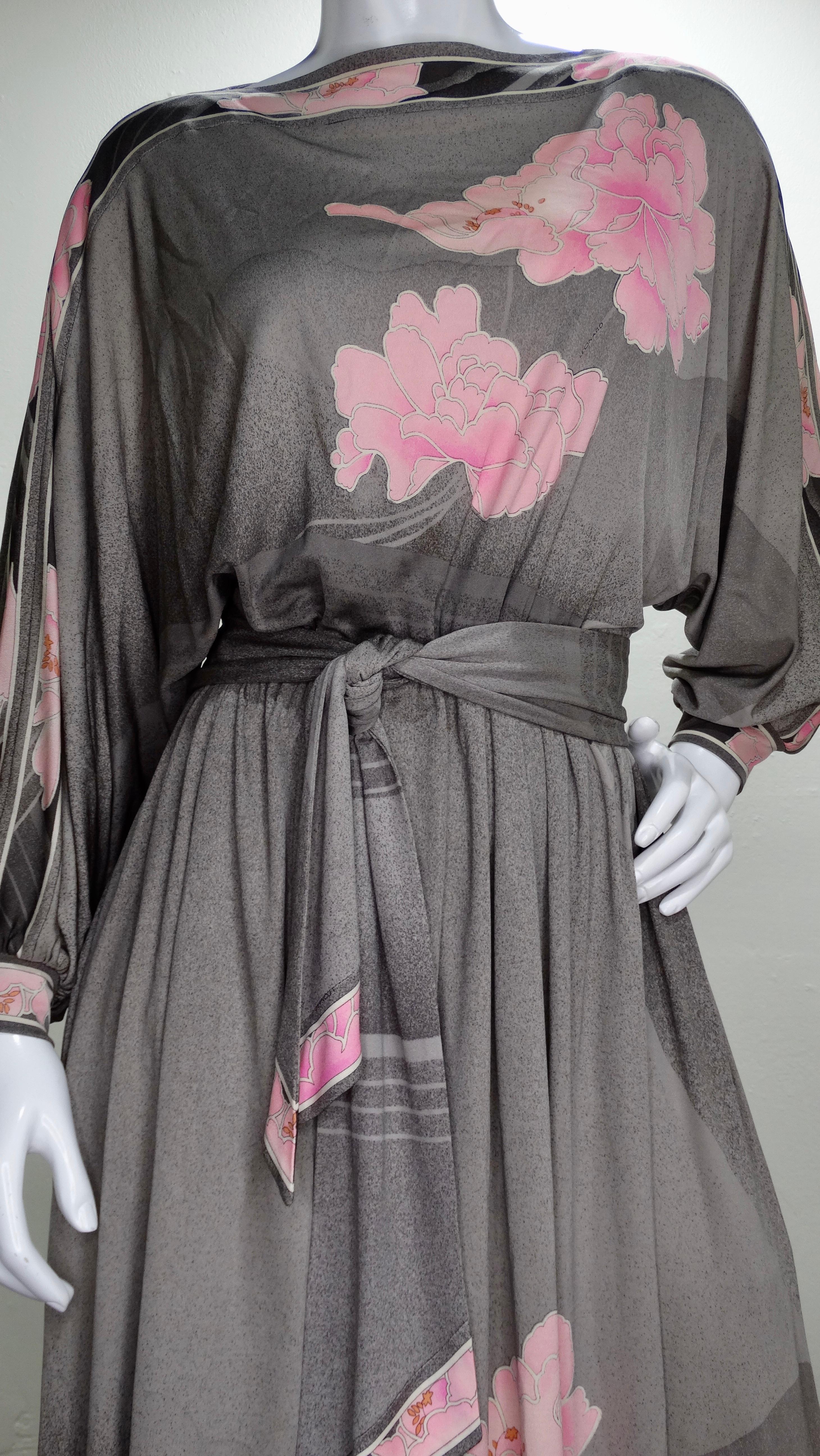 A beautiful 1970s Leonard Paris dress! Made from soft Silk Jersey, this dress features a water colored grey overall color with gradient pink floral motifs throughout. Inseam pockets, boat neckline, dolman style sleeves and a tie belt. Perfect for a