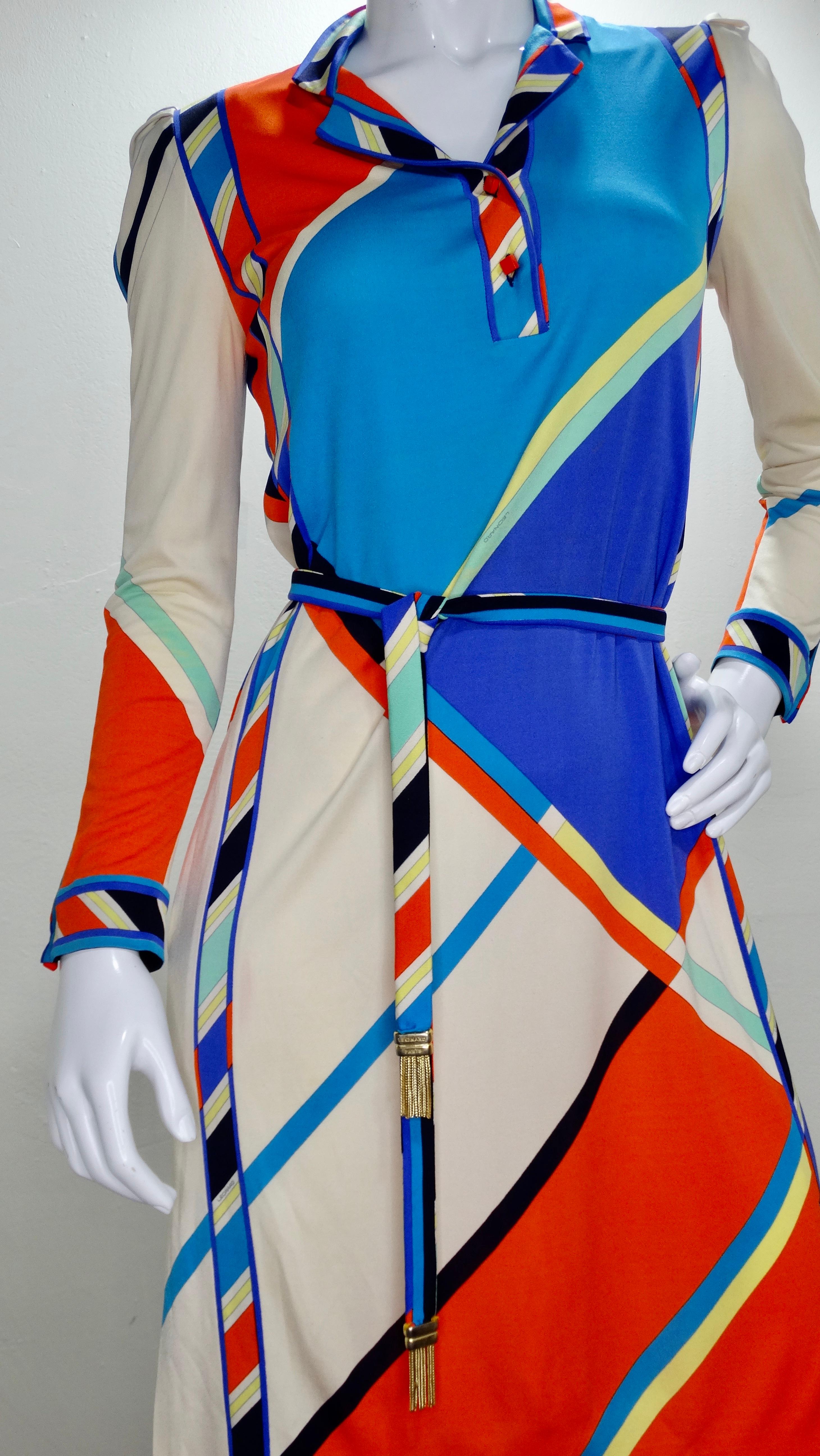 A beautiful 1970s Leonard Paris dress with some Pucci inspiration! Made from soft Silk Jersey, this dress features a multi-colored geometric print with a tassel belt and orange square buttons at the collar and cuffs. Inseam pockets and one small