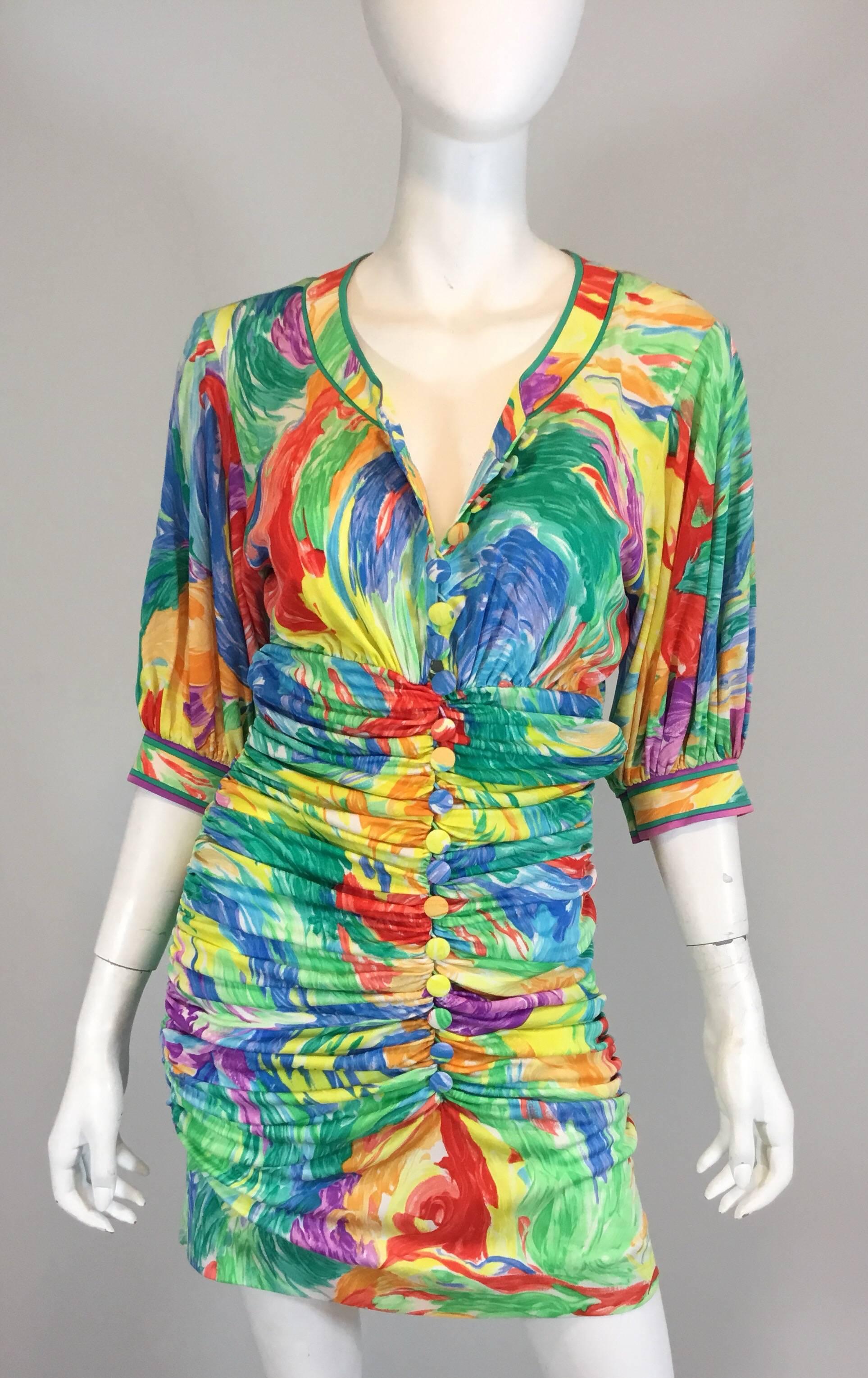 Leonard Paris silk jersey vintage mini dress features a vibrant firework print throughout with a ruched bodice, made of 100% silk jersey, and has button closures along the front. Made in France. Excellent condition. 

bust 36''
sleeves 14.5''
waist