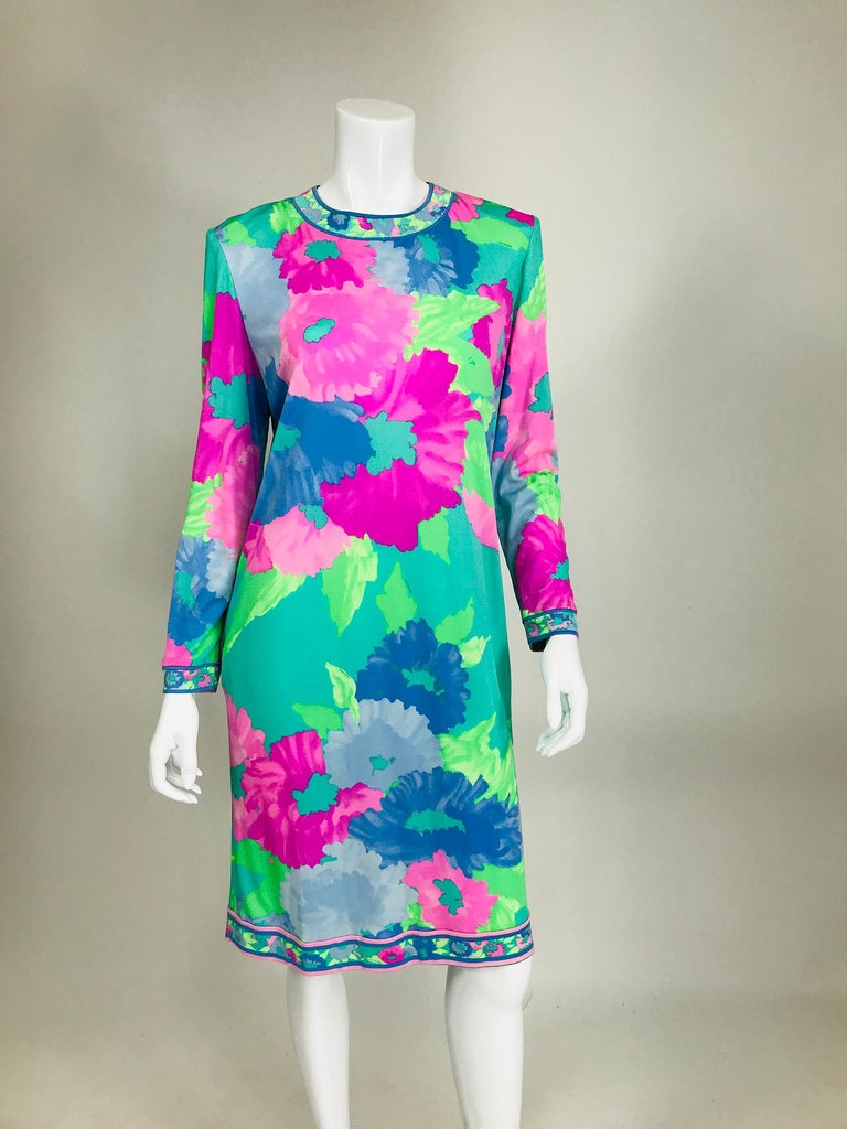 Leonard Paris floral silk jersey dress & belt from the 1980s. Floral silk jersey long sleeve dress with on seam side pockets and the original self belt with gold metal logo tabs. Mint green, blues, and pink fantasy flowers, the neckline, cuffs and