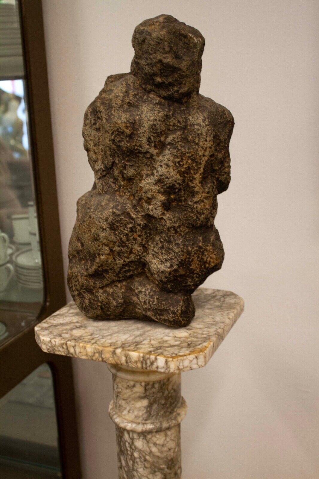 A modern organic form stone carved sculpture on a marble pedestal titled “Moses” by Leonard Schwartz. In an exhibition of his work in Detroit, a brochure stated: 
