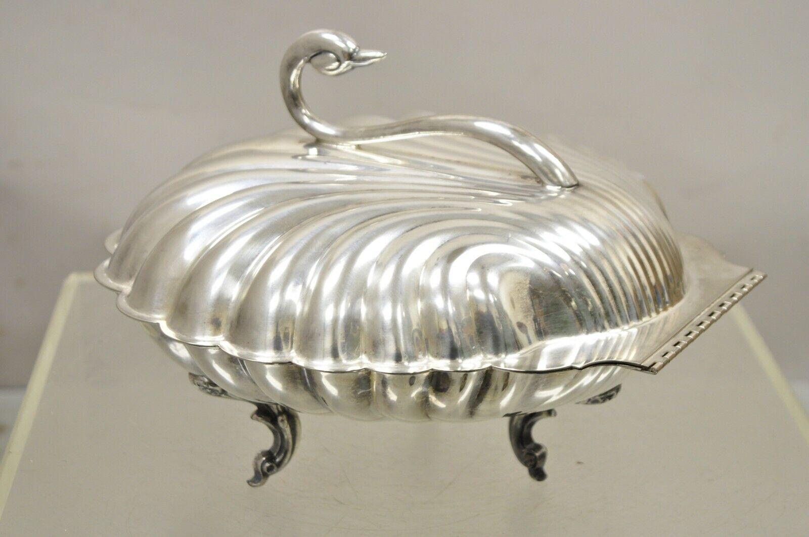 Leonard Silverplate Clam Shell Form Silver Plated Hinged Warmer with Swan. Item feature an ornate swan handle, raised on three feet, large hinged form, original hallmark. Circa  Mid 20th Century. Measurements: 8