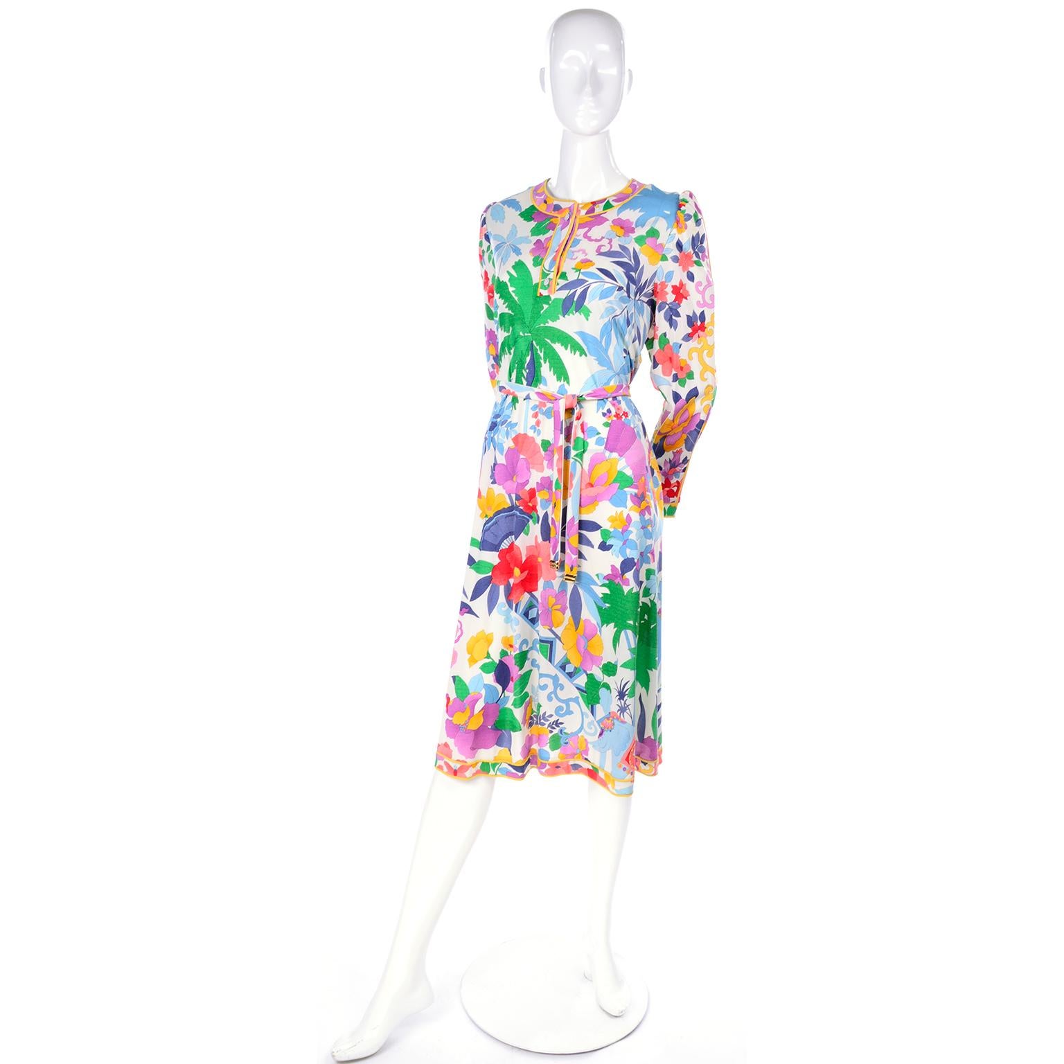 This is a gorgeous silk jersey vintage Leonard Studio dress with a signature floral print mixed with palm trees, elephants, pairs of fish and fans! It has long sleeves and has three buttons down the front, but the closure is a back zipper. It fits