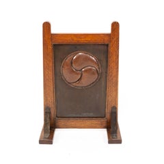 Leonard Wyburd, attri. A Rare Arts & Crafts Oak Fire Screen by Liberty & Co