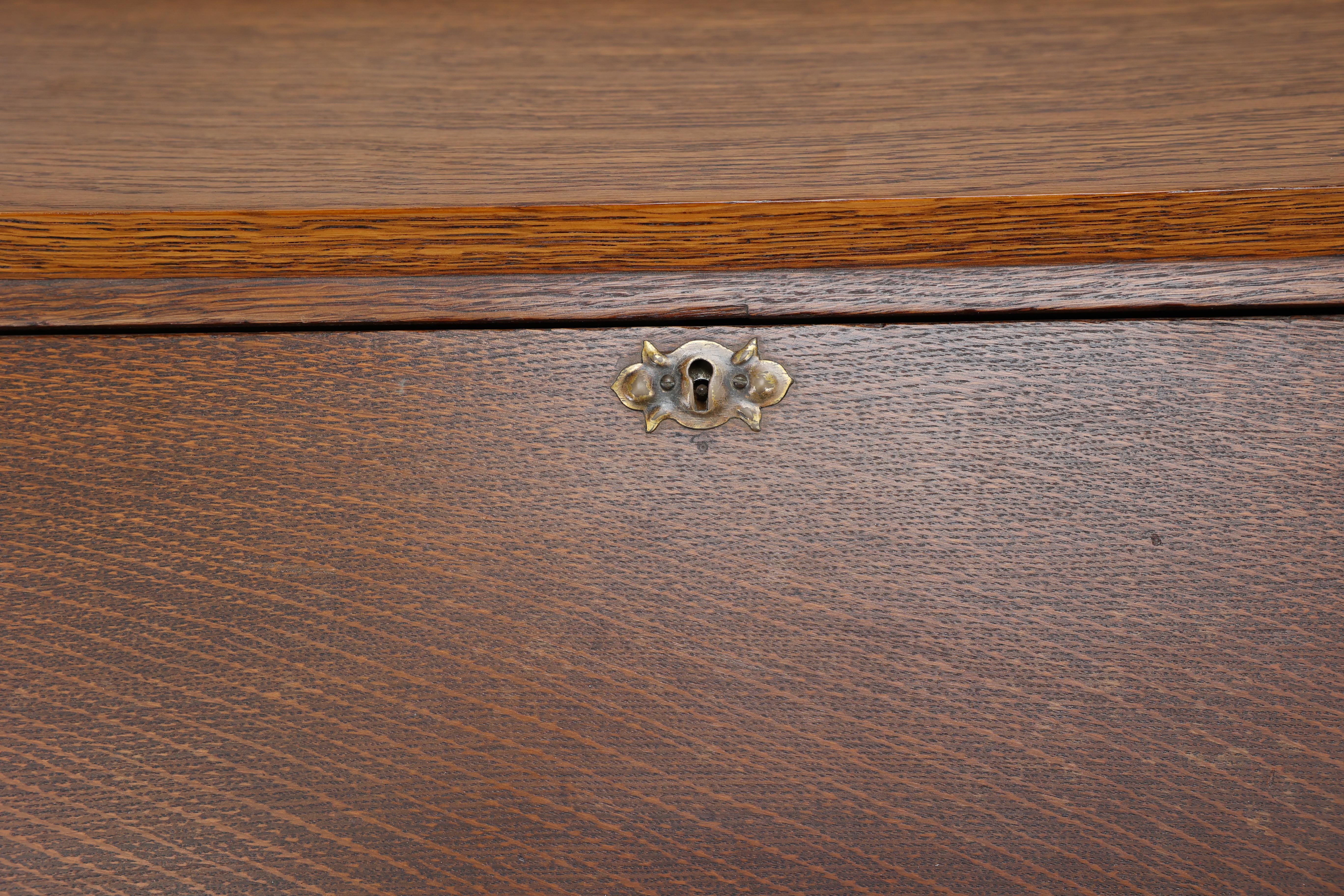Leonard Wyburd for Liberty & Co. An Arts & Crafts oak bureau with iron hinges For Sale 4