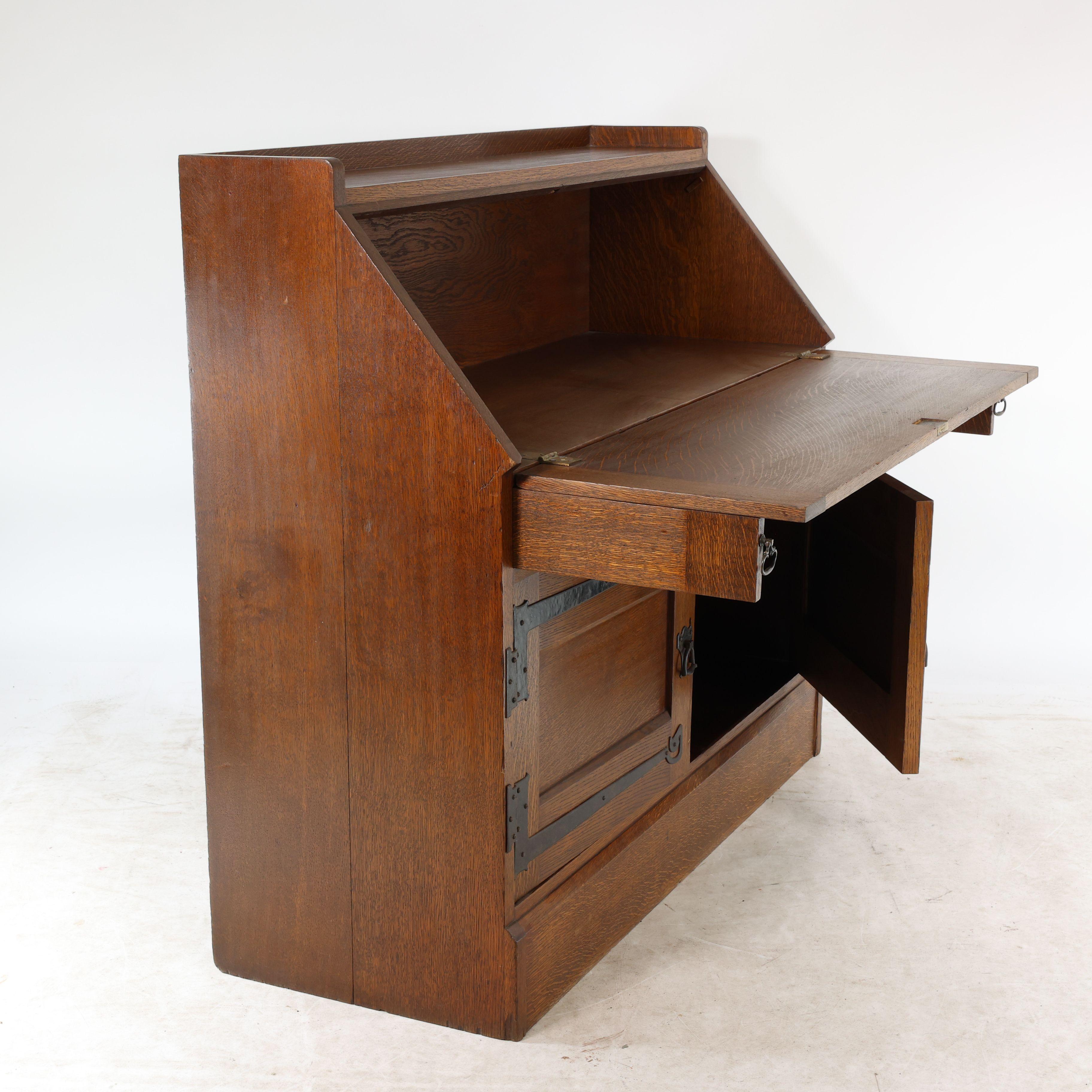 Leonard Wyburd for Liberty & Co. An Arts & Crafts oak bureau with iron hinges In Good Condition For Sale In London, GB