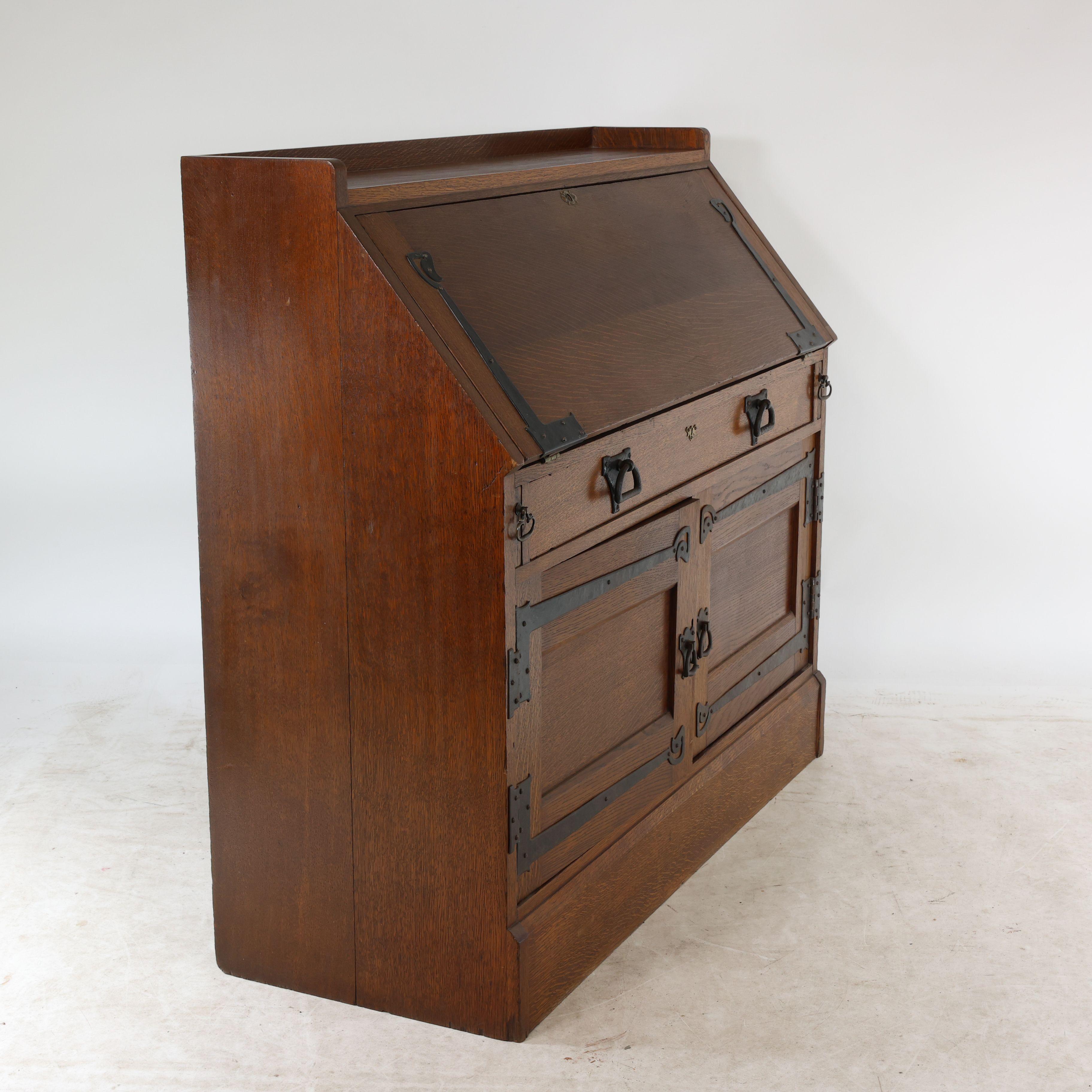 Oak Leonard Wyburd for Liberty & Co. An Arts & Crafts oak bureau with iron hinges For Sale