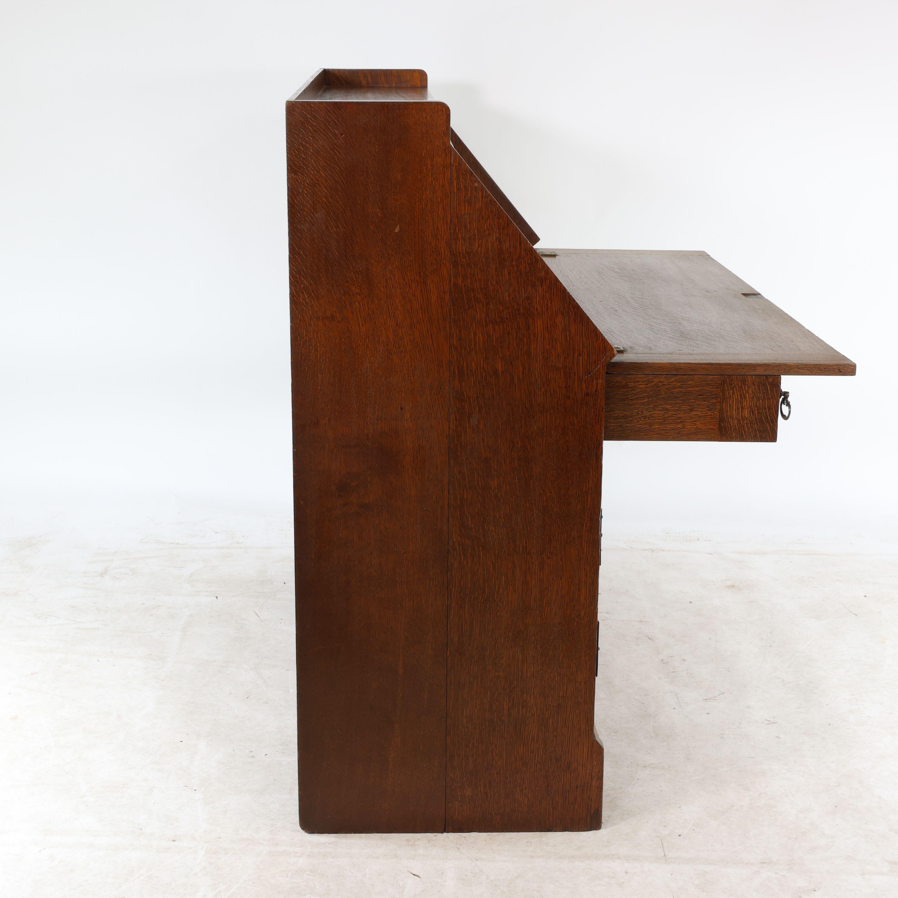 Leonard Wyburd for Liberty & Co. An Arts & Crafts oak bureau with iron hinges For Sale 2