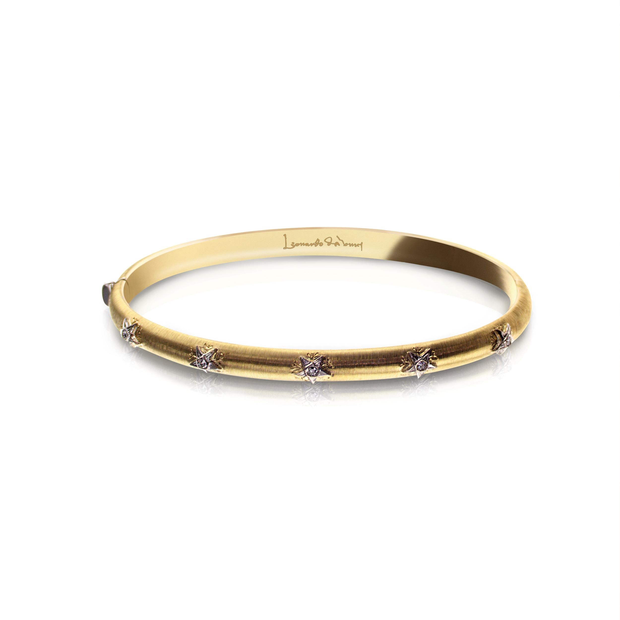 This 18kt Yellow Gold Caterina Collection Bangle Bracelet with a matted shimmer, was designed and inspired by Leonardo da Vinci's architectural drawings.

Decorated with 5 white Gold stars on the face of the bangle with his internationally patented