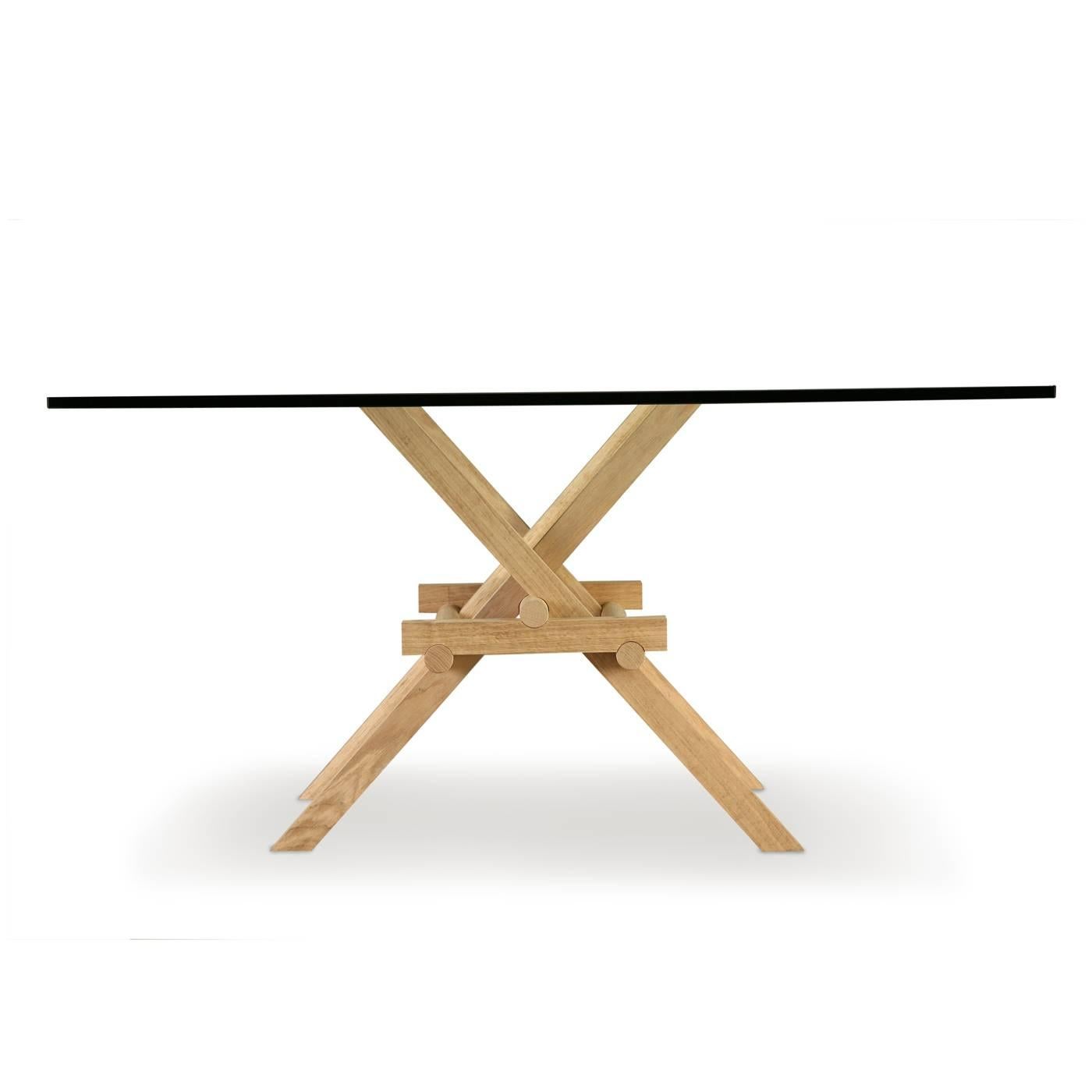 Marco Ferreri was inspired by Leonardo da Vinci's mobile bridges in designing this dining table that features a system of legs made of solid ashwood that are connected through a skillful combination of joints, giving it the solid strength to support