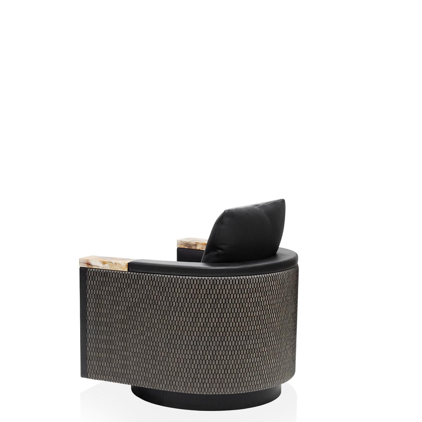 Characterized by rounded volumes, sophisticated upholstery and sartorial manufacturing, the Leonia armchair expresses a bold yet contemporary style. The external shell is covered with Kotakot upholstery, a refined interweaving of leather and cotton