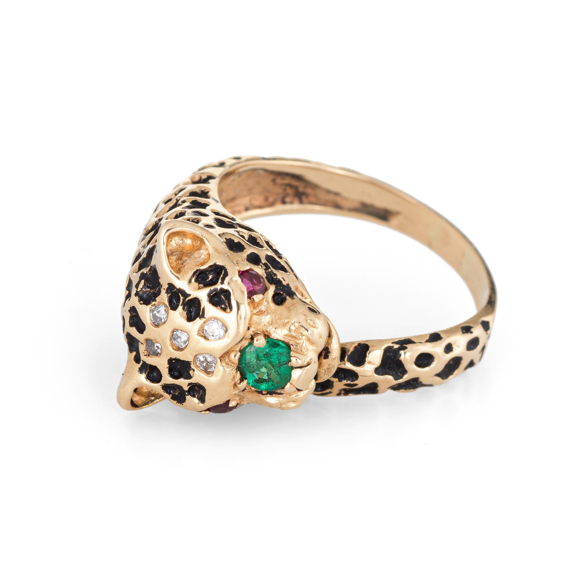 Finely detailed vintage leopard ring (circa 1960s to 1970s) crafted in 14 karat yellow gold. 

One estimated 0.10 carat emerald is set about the nose with two estimated 0.01 carat rubies set into the eyes. Five diamonds total an estimated 0.03