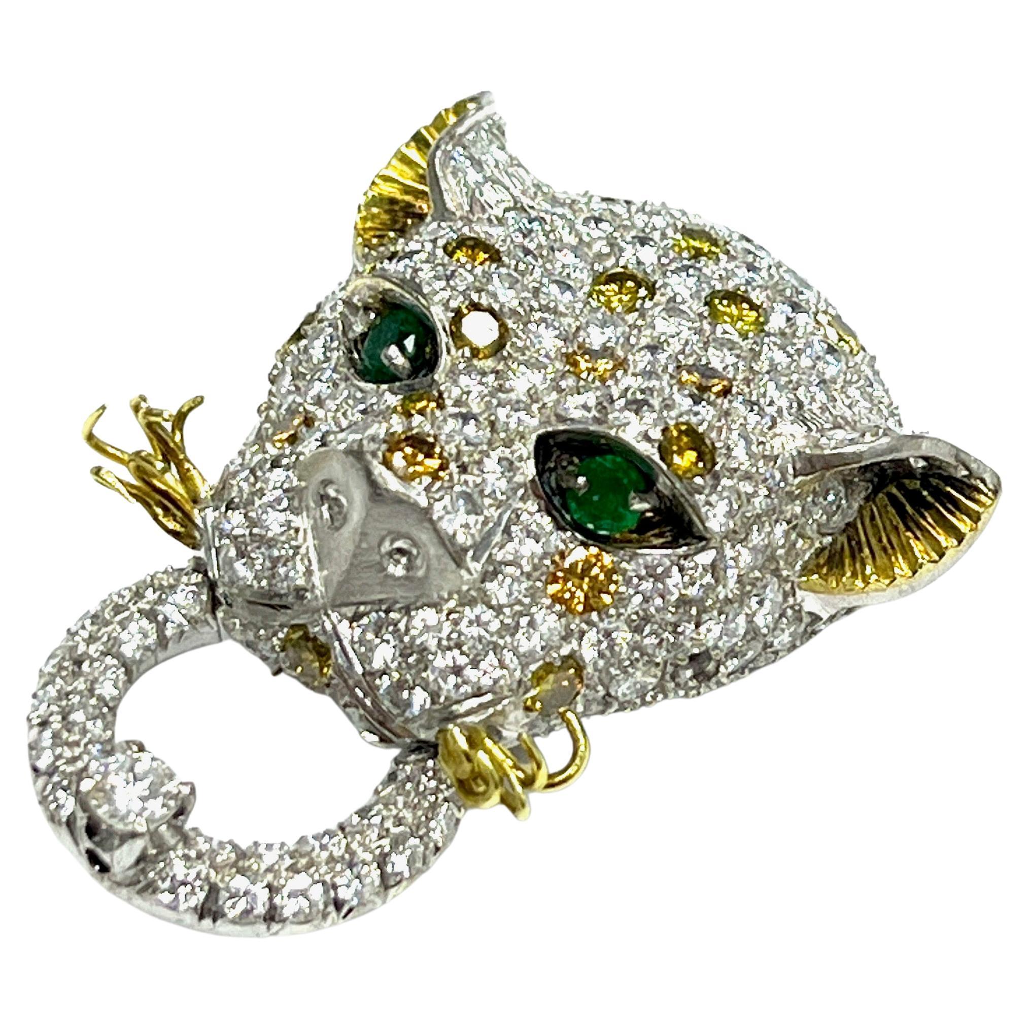 Leopard Diamond Emerald White & Yellow Gold Brooch

Two hundred twenty-six round brilliant-cut diamonds of approximately 15.82 carats total, with SI1 clarity, and twenty irradiated yellow and two hundred six H color; two natural emeralds for eyes of