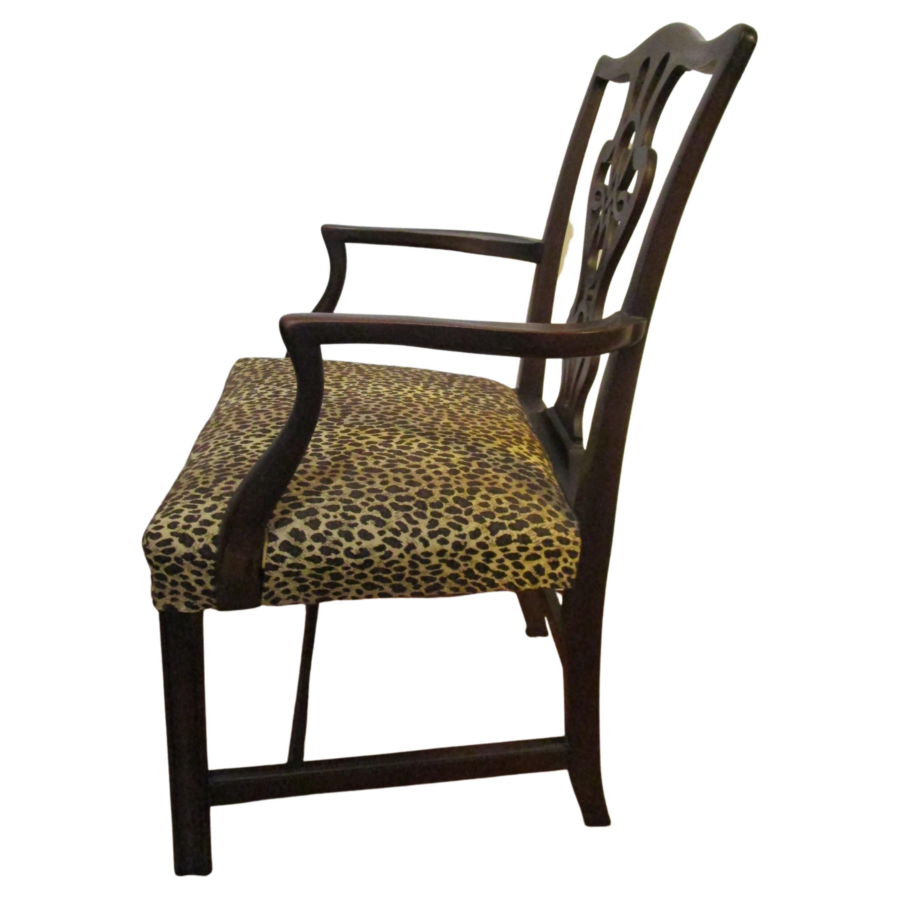 The patina and quality of this late 19th century transitional Chippendale armchair from the Federal period is a standout. It is the deepest tone mahogany. The contrast of Chippendale, covered in a later modern leopard pattern is quite smart. The