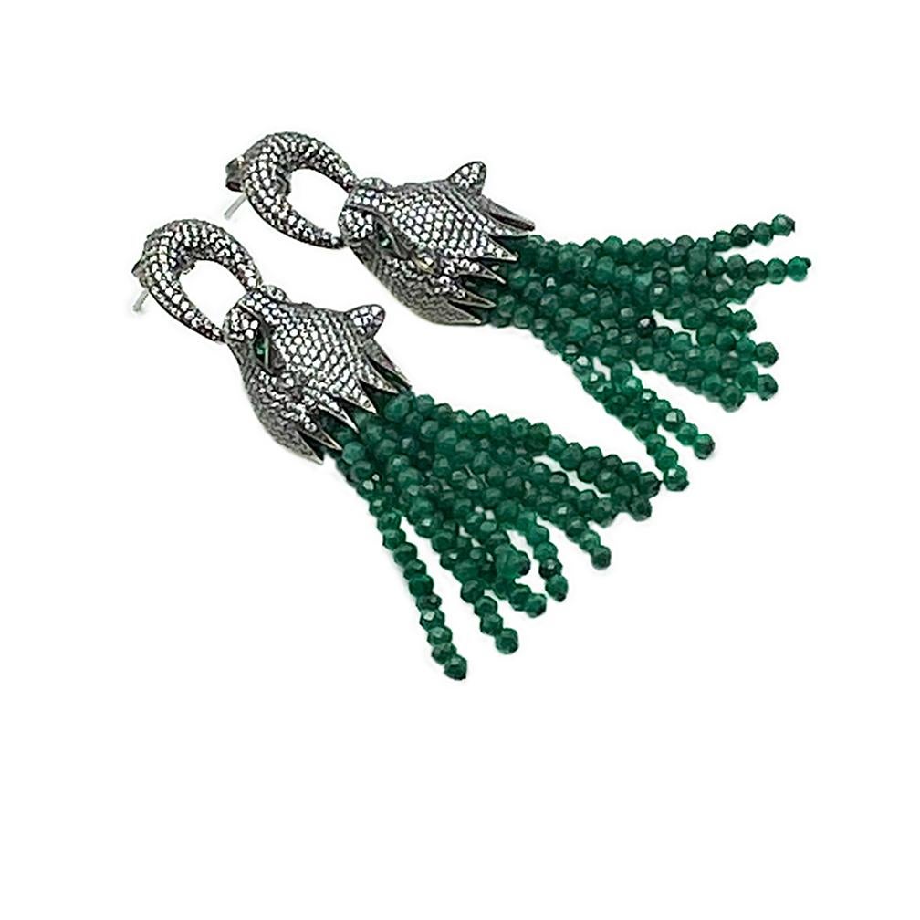 This is a pair of dragon head post earrings with emerald tassels. These sterling dangle earrings each has a dragon's head with green eyes and pavé-set crystal biting a ring. A 1.5 inch long opaque emerald beaded tassel is it's body. Year of Dragon