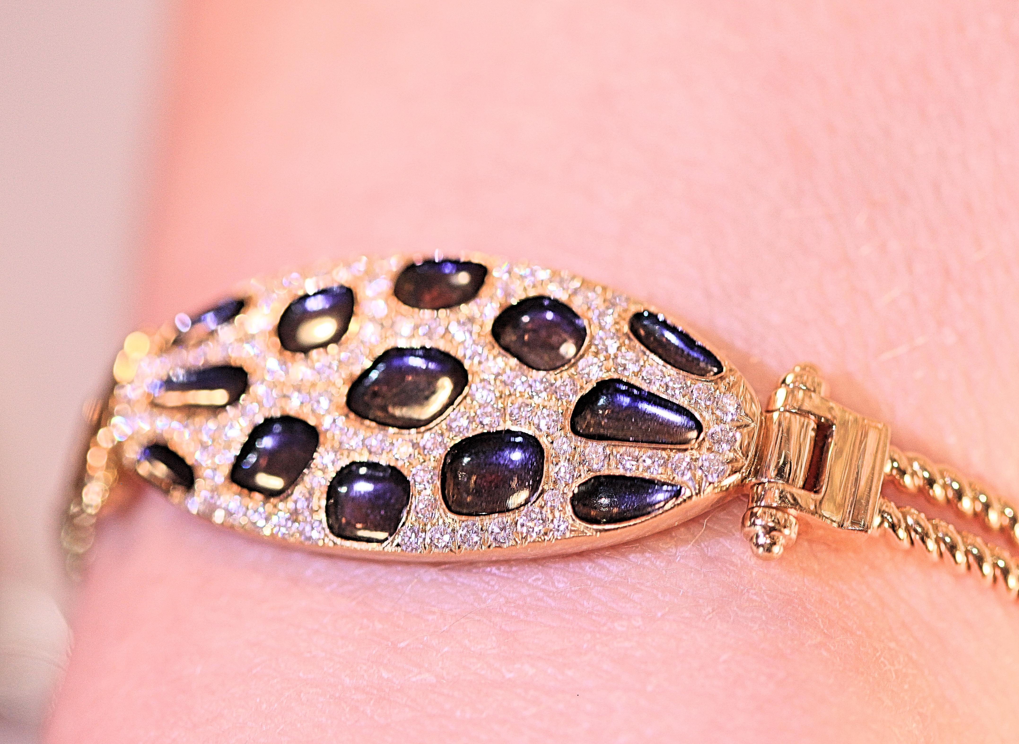 Check this bracelet out!!!  A heavy, 18 karat yellow gold hinged bracelet with enameled spots and diamonds.  The diamonds are round brilliant cut and they weigh .99 carat total. The diamonds are white and pave' set around the black enameled spots. 