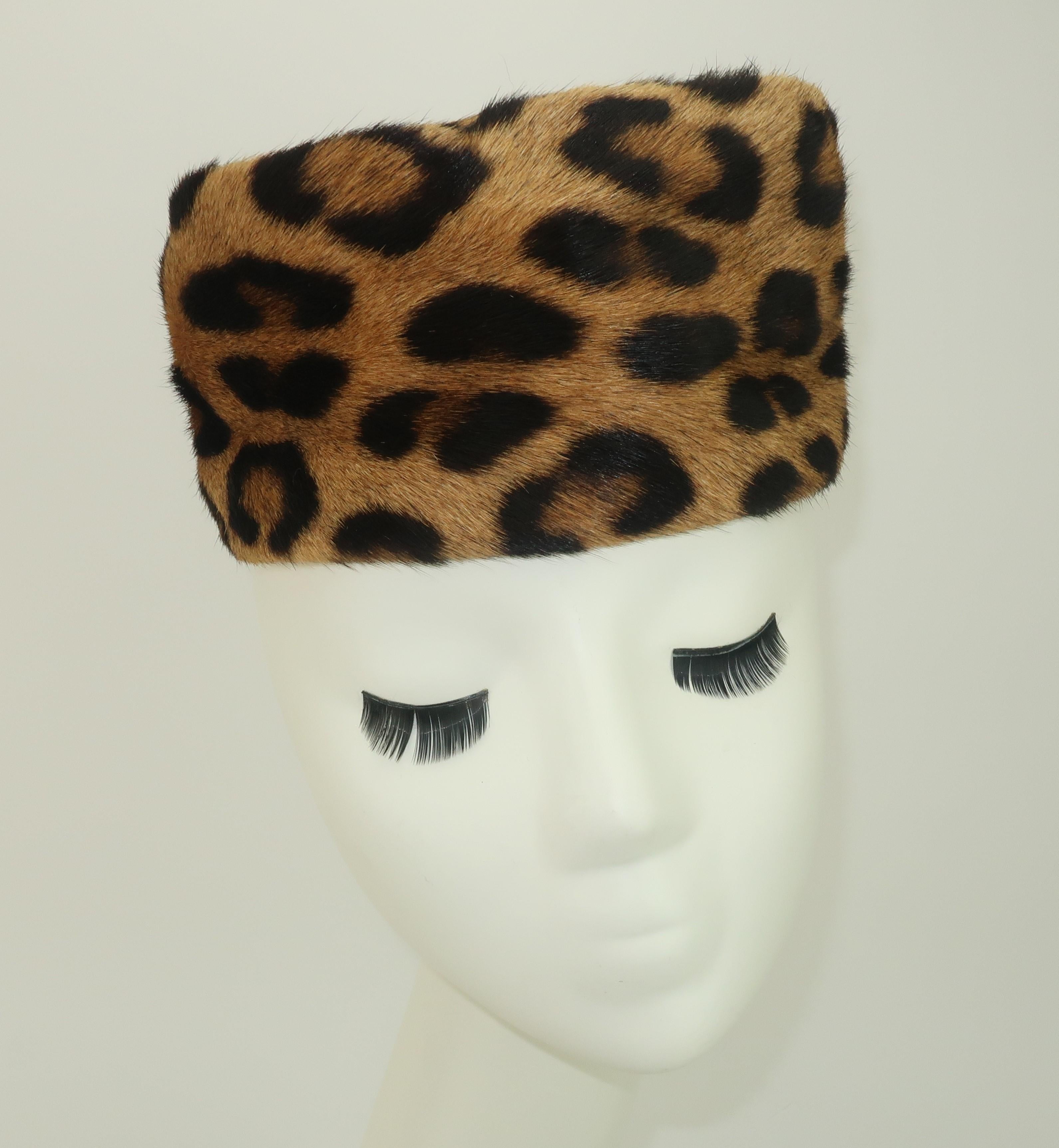 Add an exotic flavor to your wardrobe with this fashionable leopard printed fur pillbox hat. The minimalist shape can be worn forward, back or cocked to one side. Lined with black satin fabric and a grosgrain rim.  Purrrfect for a touch of vintage